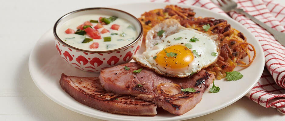 Bone-In Ham Steak with Hash Brown Cakes, Fried Egg, and Queso Sauce | Smithfield