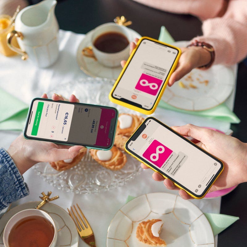 A group of hands holding mobile phones.