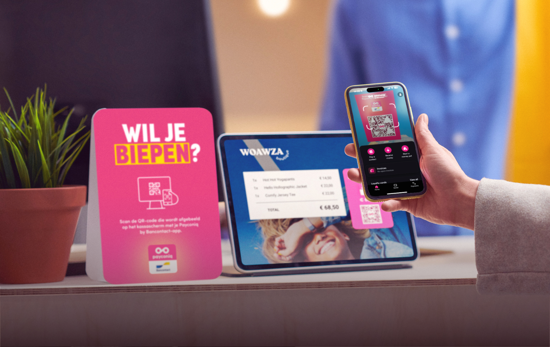 A hand with a phone and a tablet