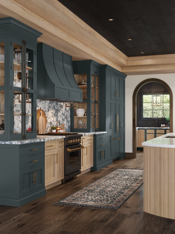 A kitchen with contrasting green painted and stained wood cabinets and island.