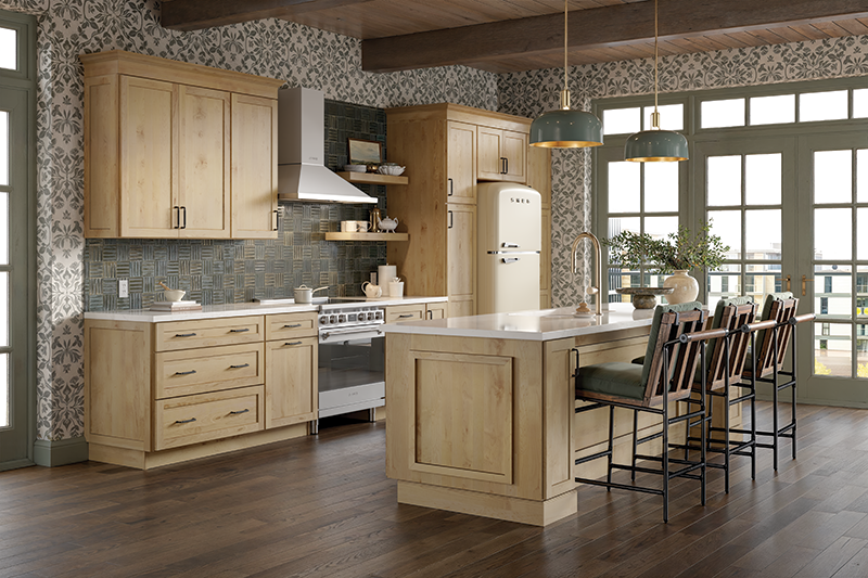 A kitchen featuring wood floors, light wood stained cabinets, and a kitchen island with dining chairs.