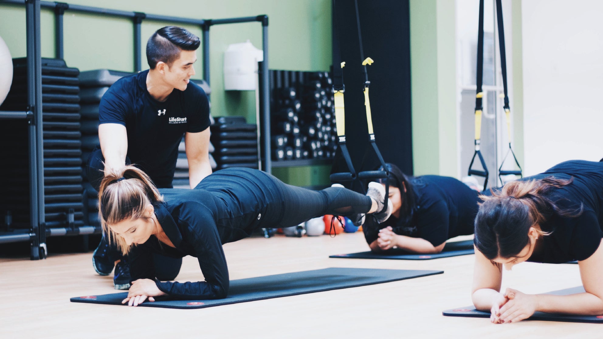 An instructor leading an exercise class in the Laitram fitness center