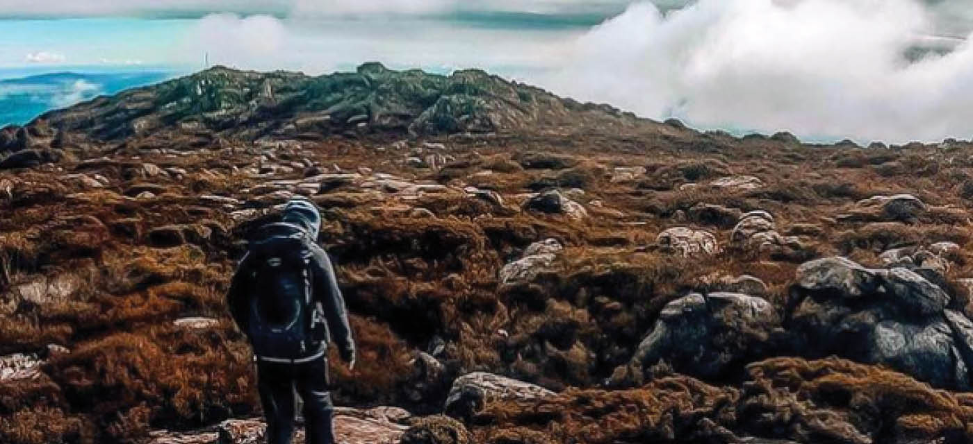 Person walking on top of a mountain