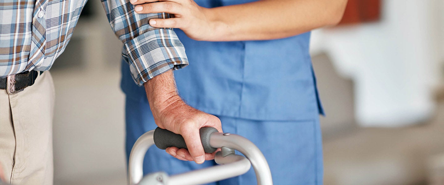 Elderly person using walker