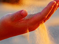 Sand falling through someones hand