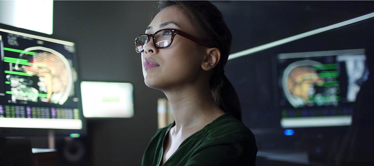 Female radiologist looking at computer screens
