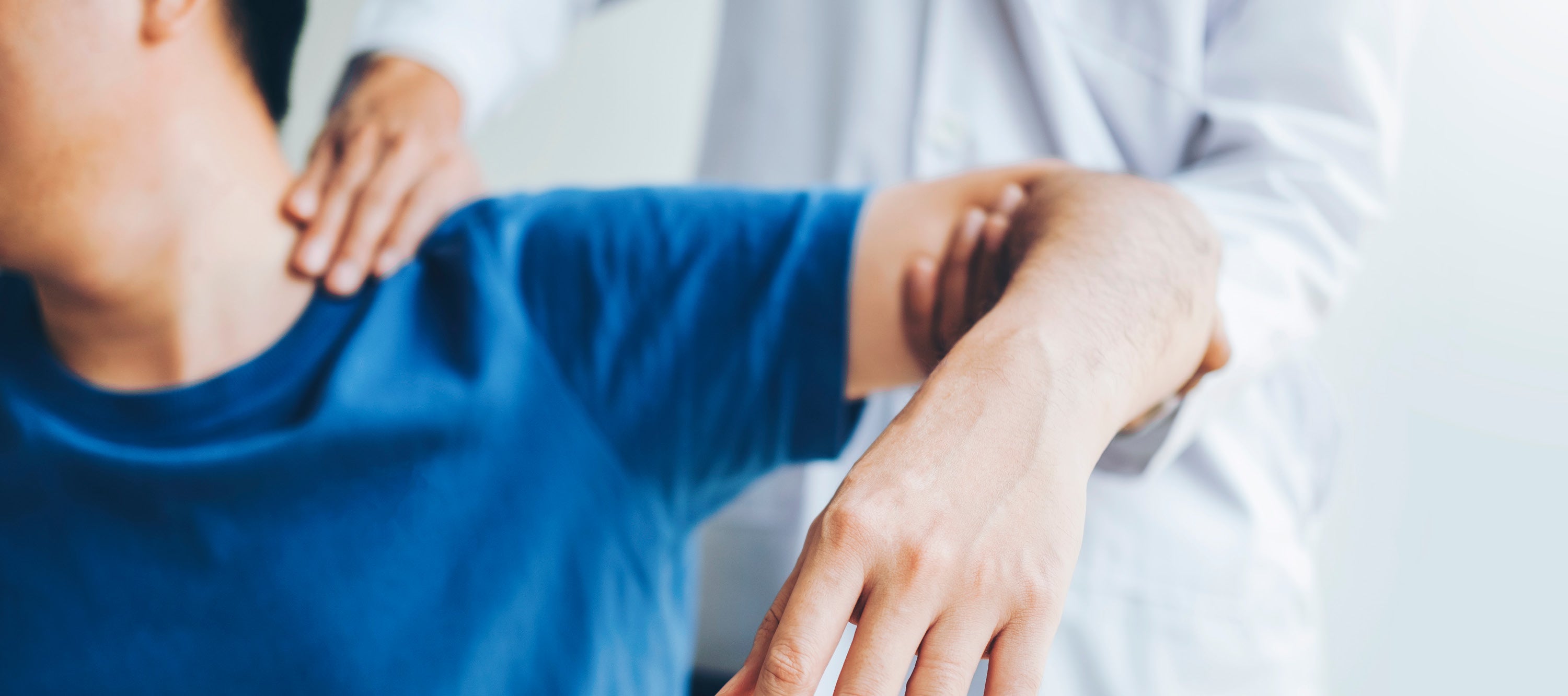 Doctor examining a patients shoulder