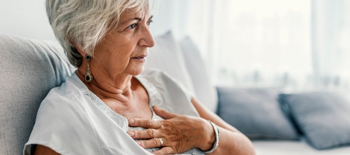 Woman holding her chest with pain