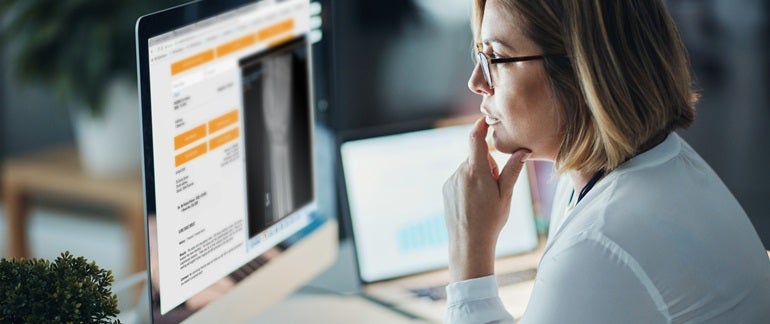 Doctor looking at desktop