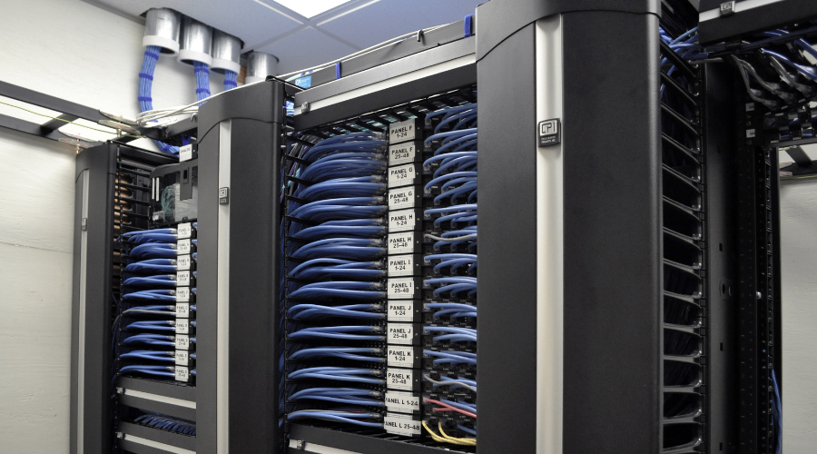 Server racks organized with neatly managed blue Ethernet cables, featuring Chatsworth Products cable management systems.