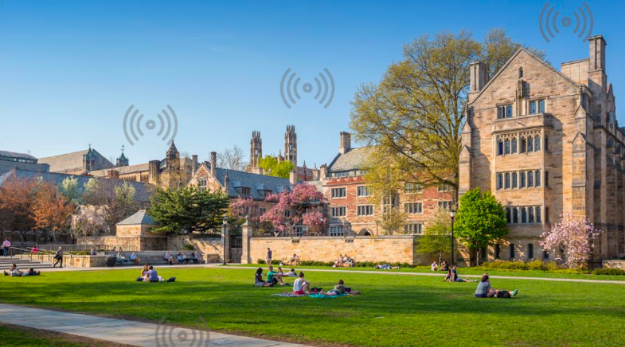 University campus with students on the lawn, symbolizing wireless connectivity through overlayed Wi-Fi signal icons.