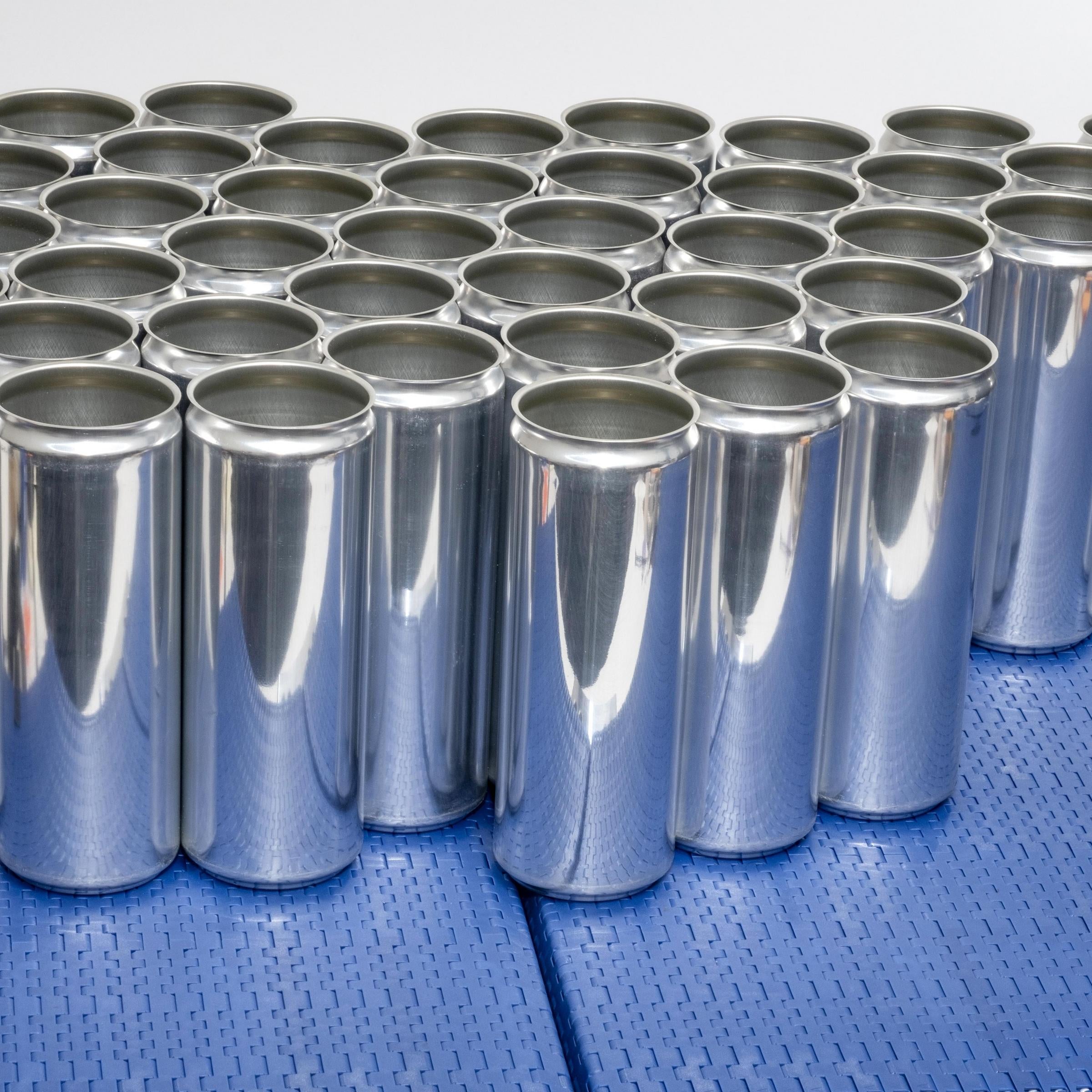 Tall metal cans with no lids on blue conveyor belt