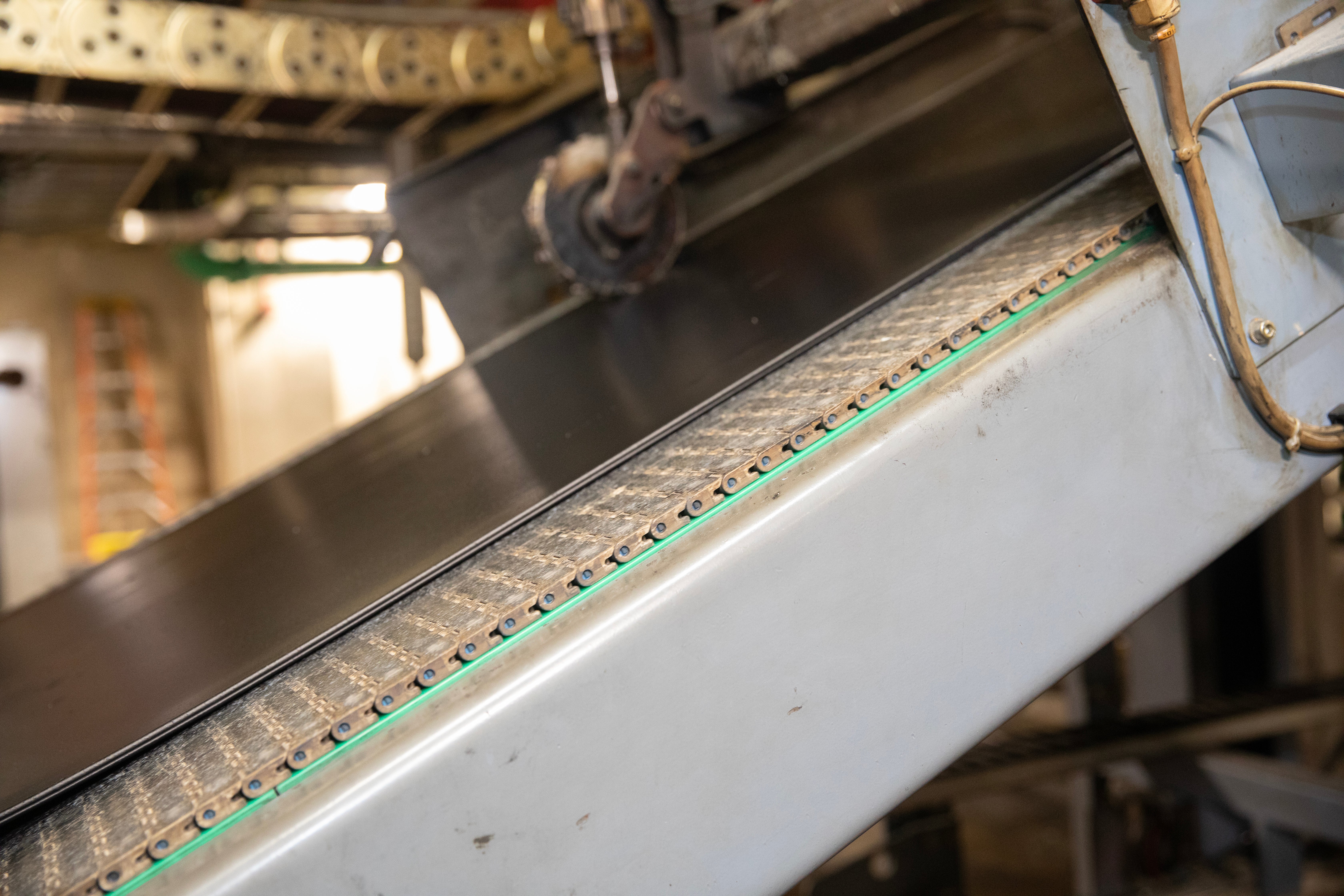 Tire rubber on inclined conveyor with gray belt
