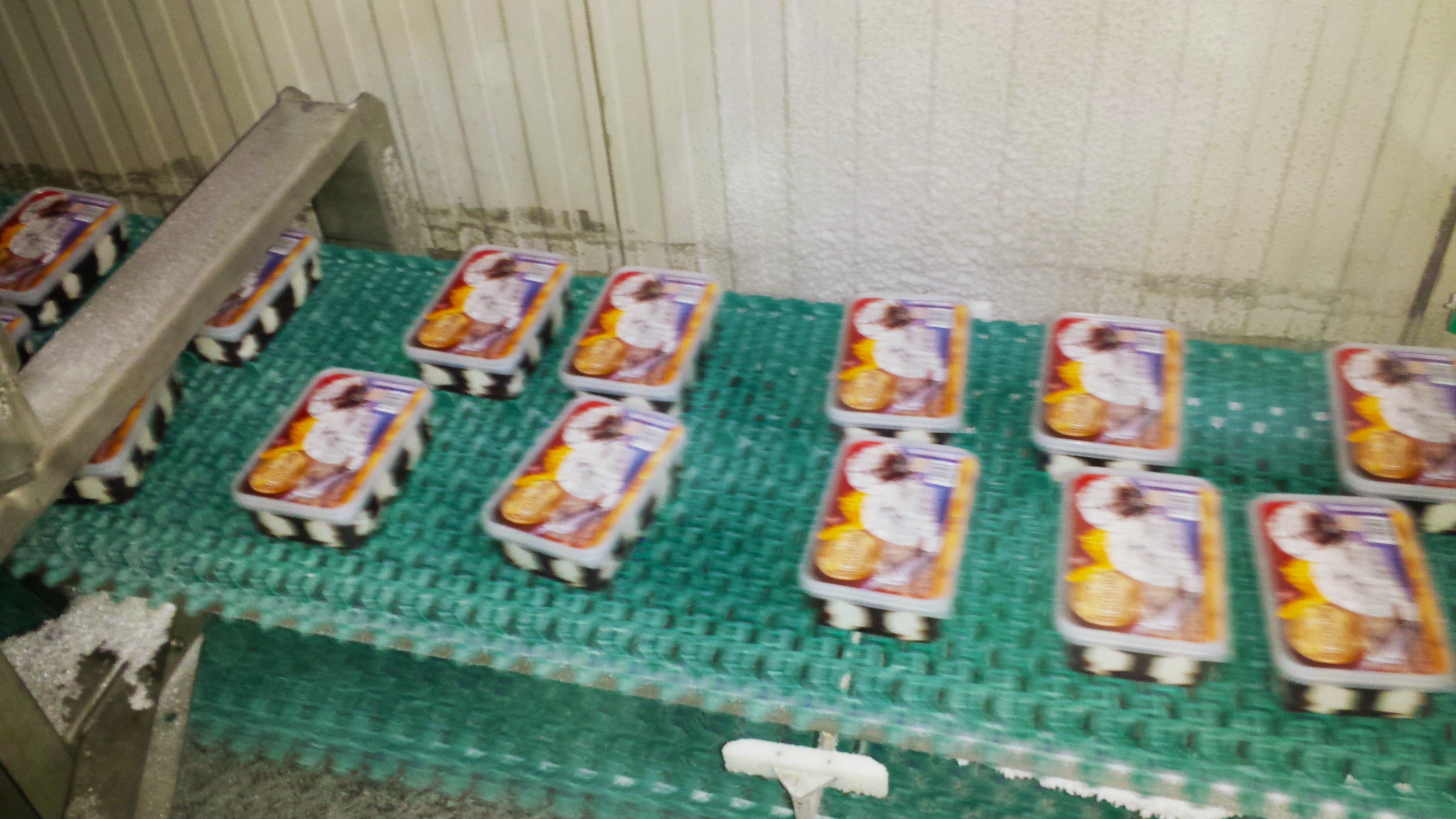 Ice cream containers on conveyor belt