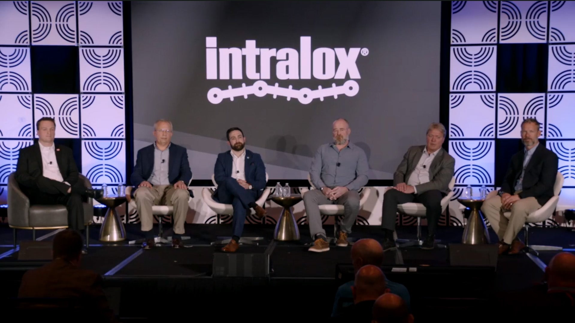 Painel de especialistas em uma mesa discutindo sobre automação na fabricação