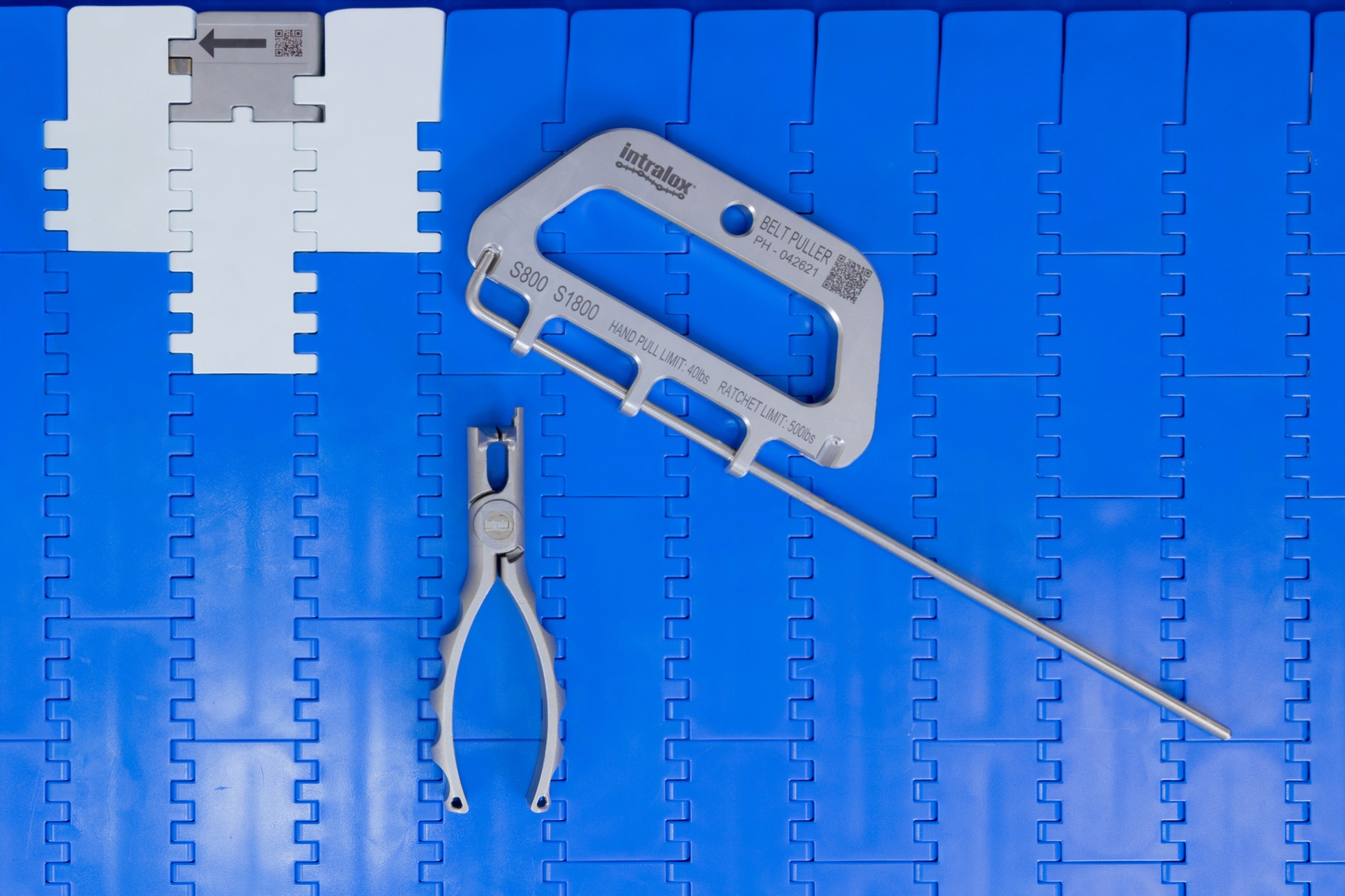 Intralox Rod Remover, Belt Puller, and Clean Release tools on blue conveyor belt