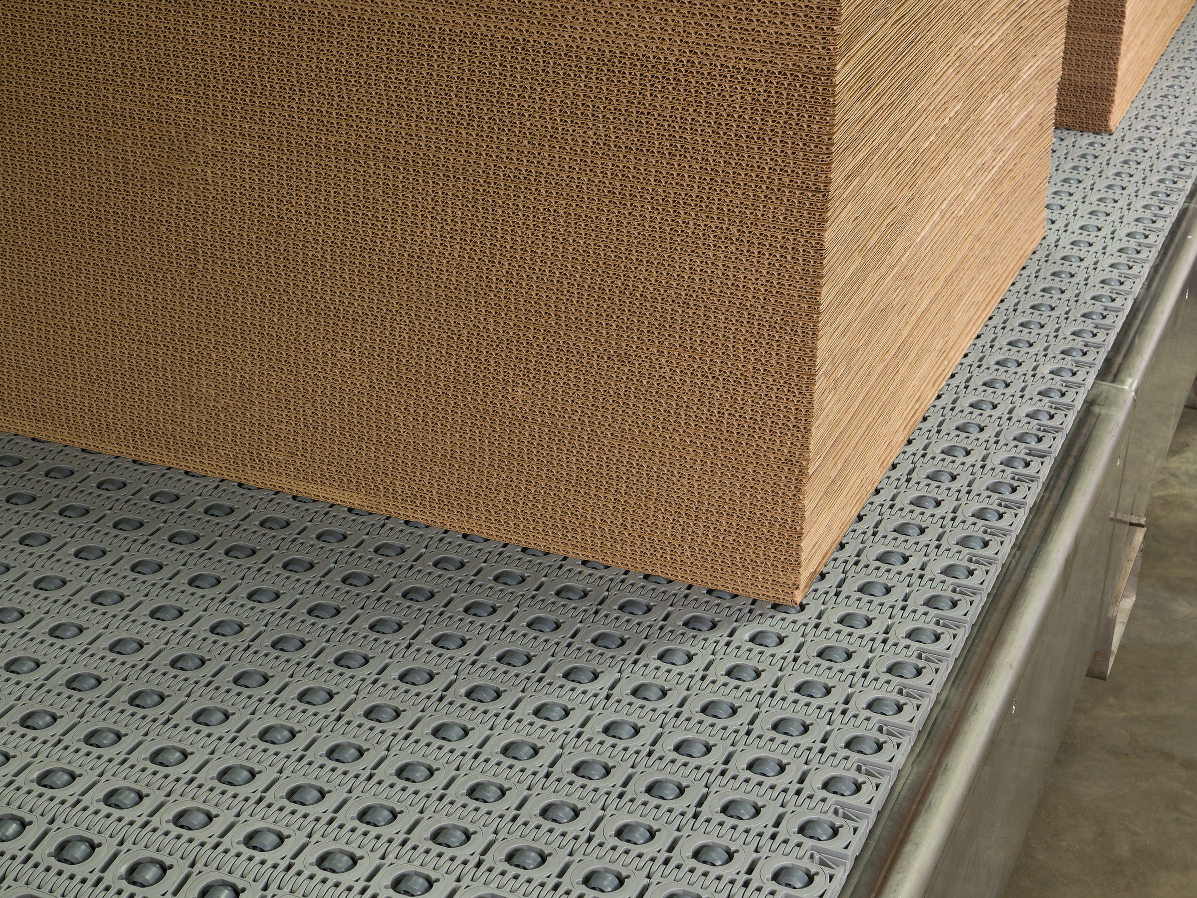 Stack of corrugated cardboard on Activated Roller Belt