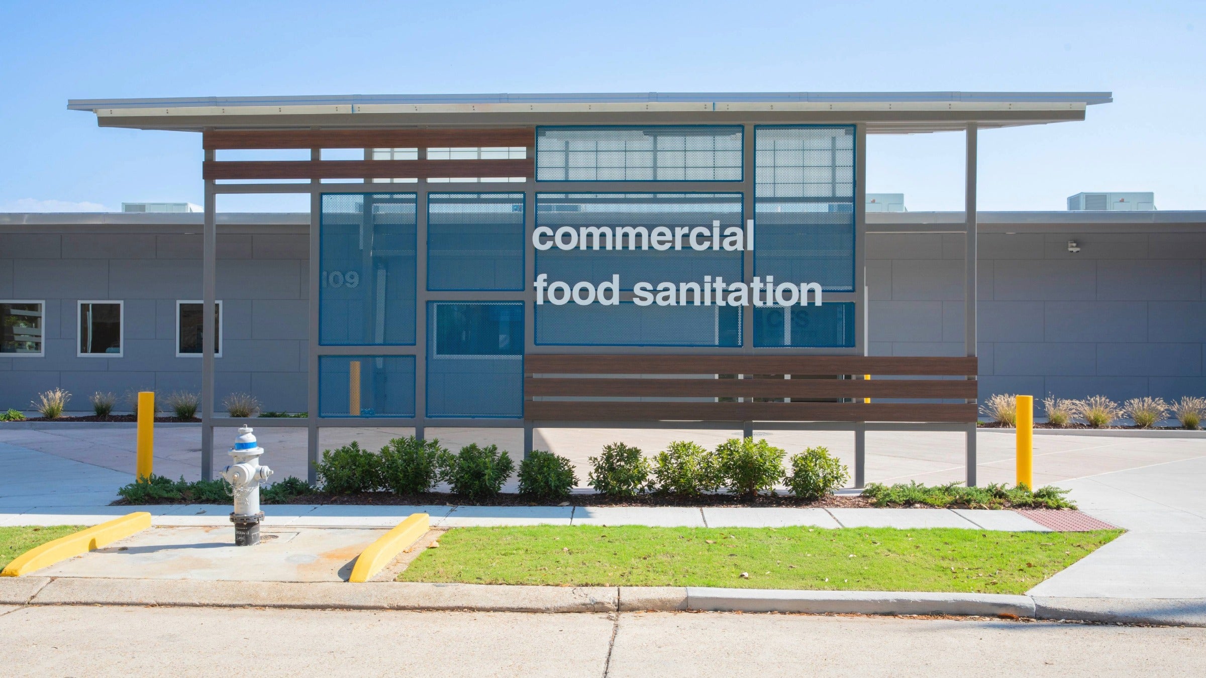 Exterior of building with sign that reads "Commerical Food Sanitation"