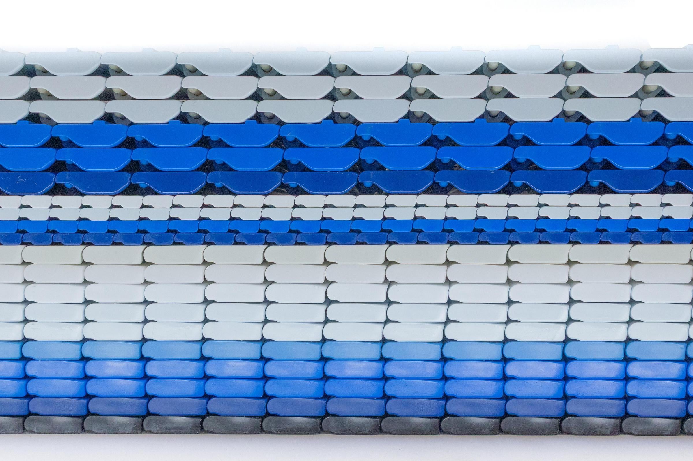 Side profile of several different Intralox Heavy-Duty Edge (HDE) conveyor belts stacked atop each other