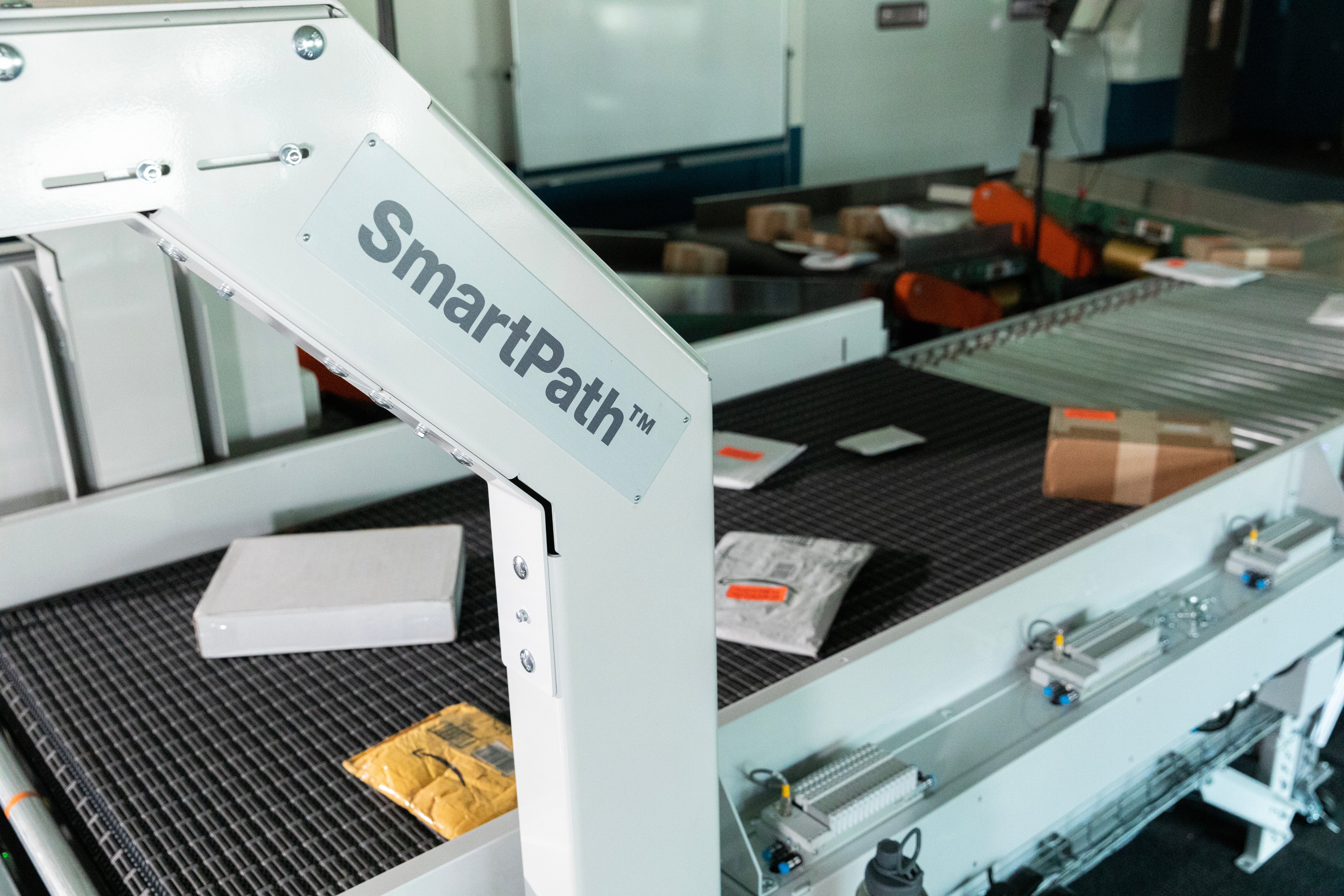 SmartPath Singulator and Gapper with packages and signage