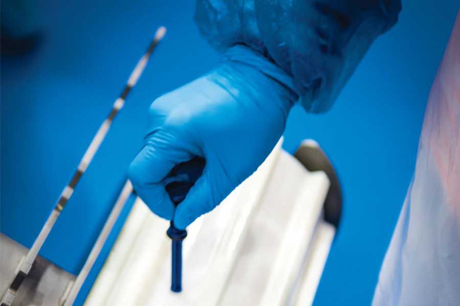 Hand with sterile glove adjusting sprocket screw