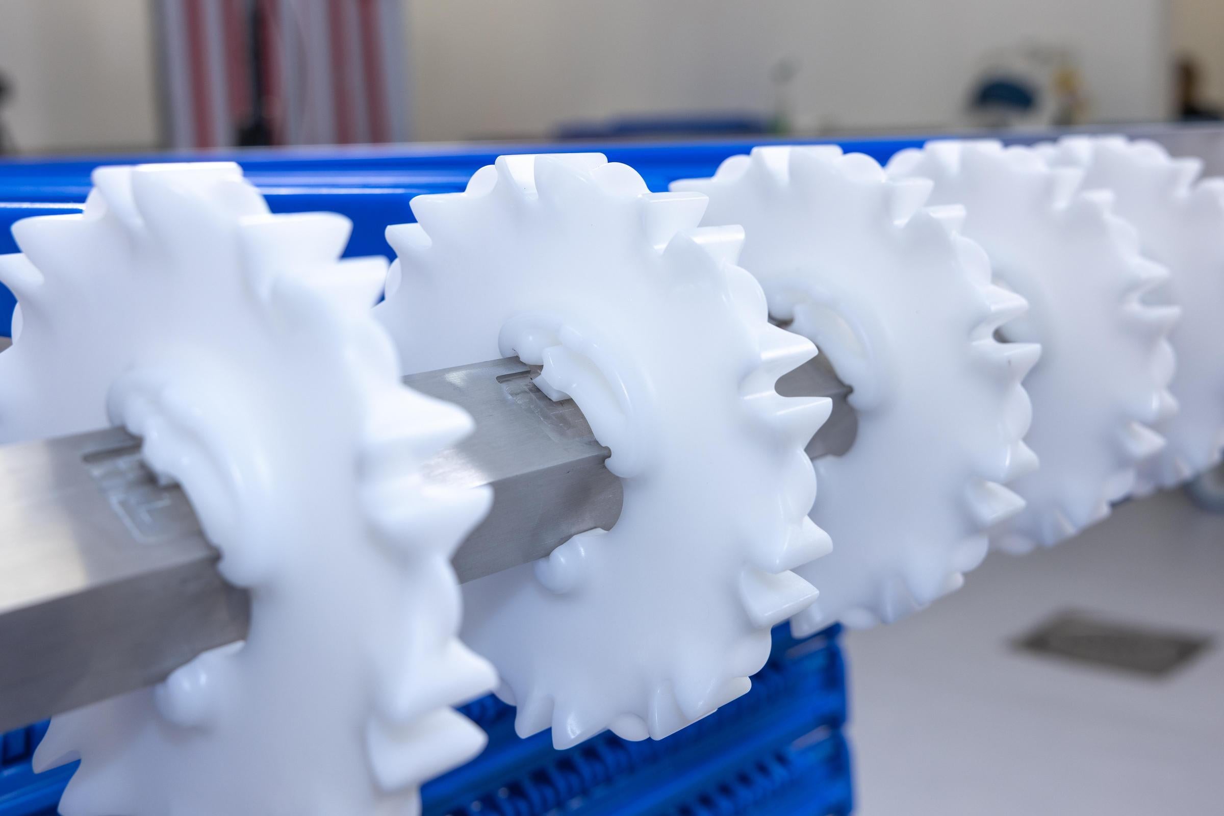 White CleanLock sprockets on conveyor shaft