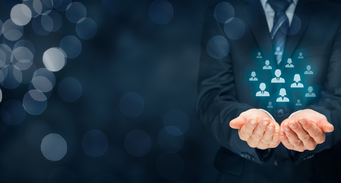 Business man virtally holding silhouette icons of people in his hands.