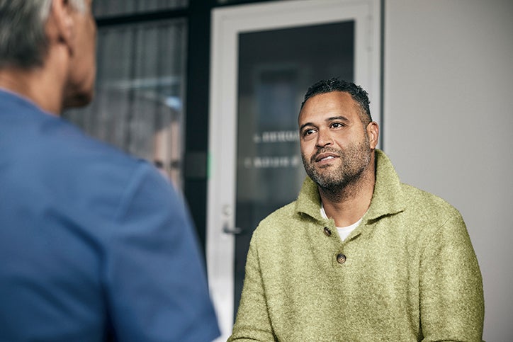 man speaking to a medical professional