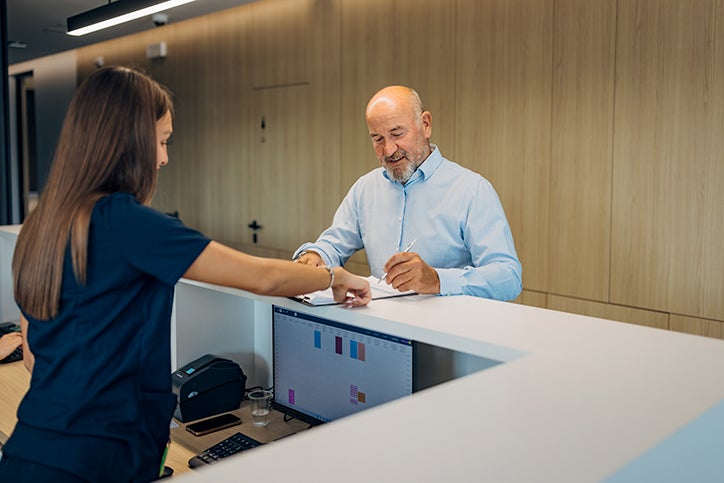 A man working through same documents at a counter