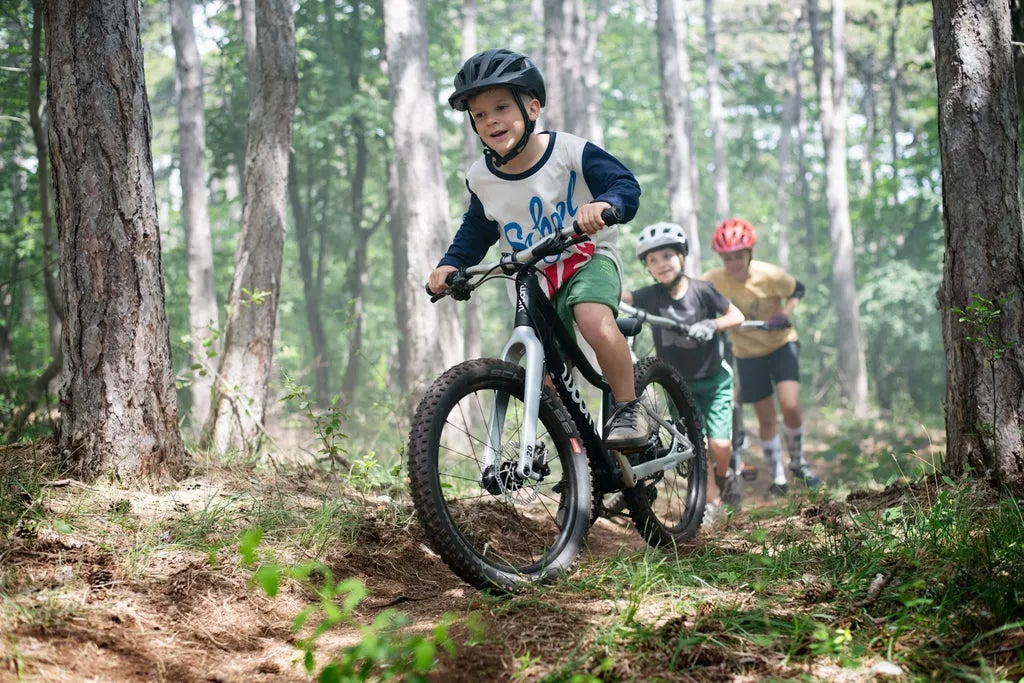 boy riding a mountain bike in a forest