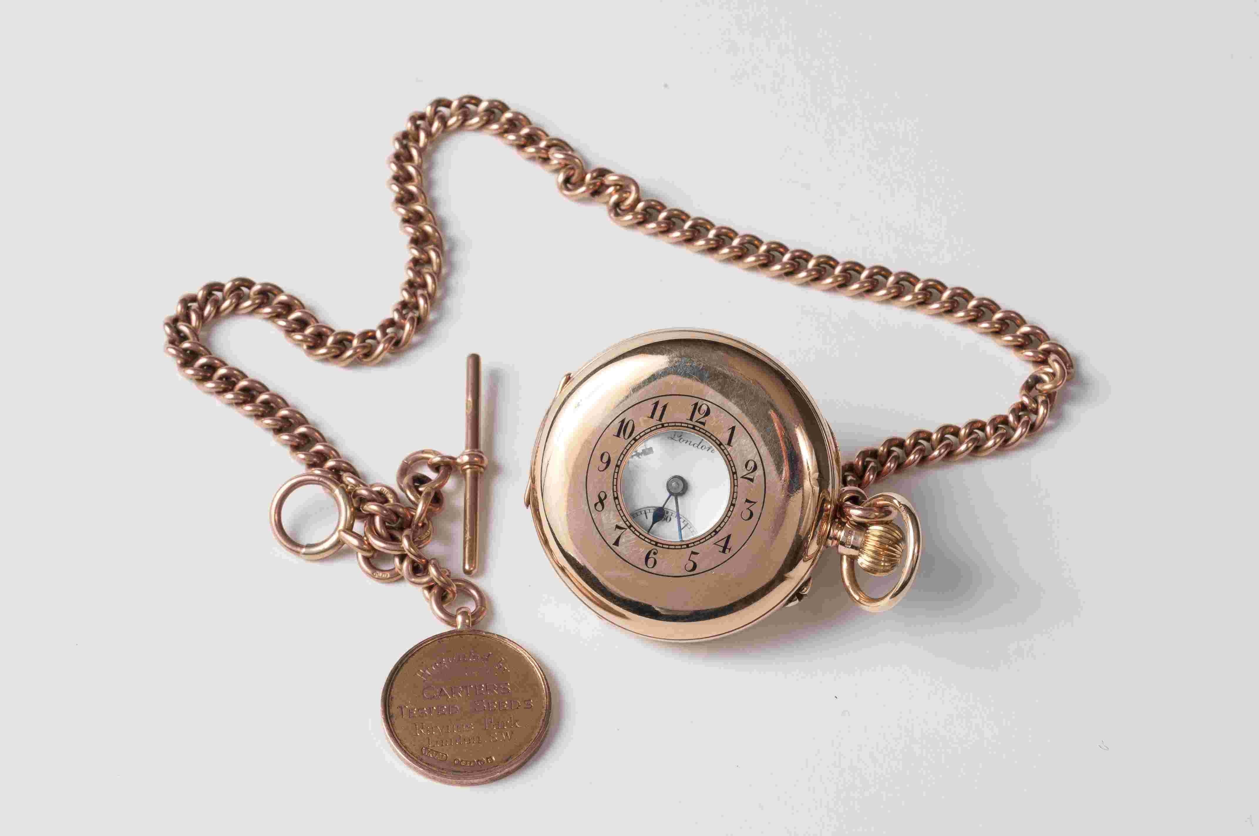 Jim Barnes Pocket Watch. Round, gold watch with gold chain.