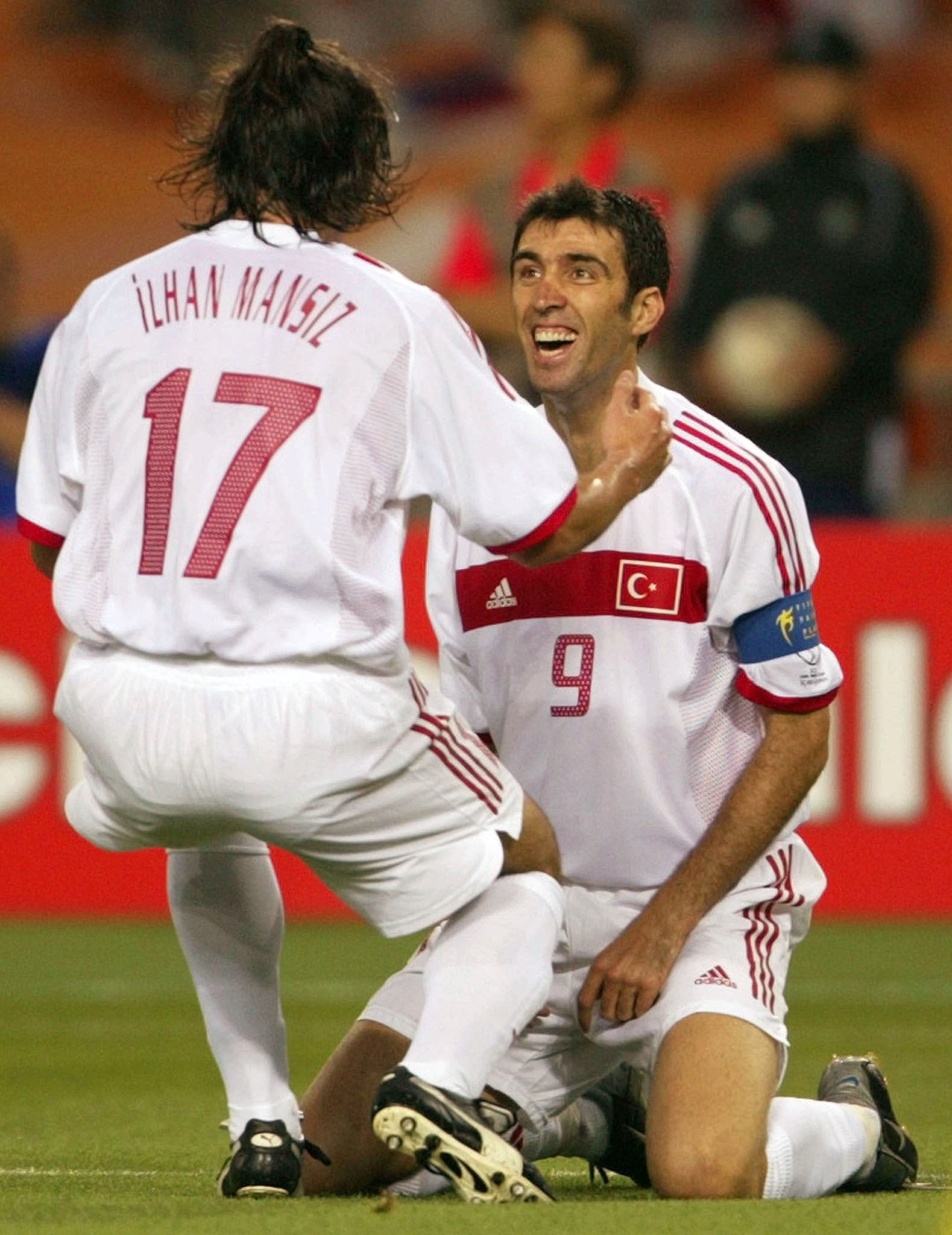 Turkey's Ilhan Mansiz (L) is congratulated by teammate Hakan Sukur after scoring Turkey's second goal against South Korea at their World Cup third place play-off match in Taegu June 29, 2002. Sukur scored the fastest goal in World Cup Finals history. REUTERS/Desmond Boylan RCS/JP/JD
