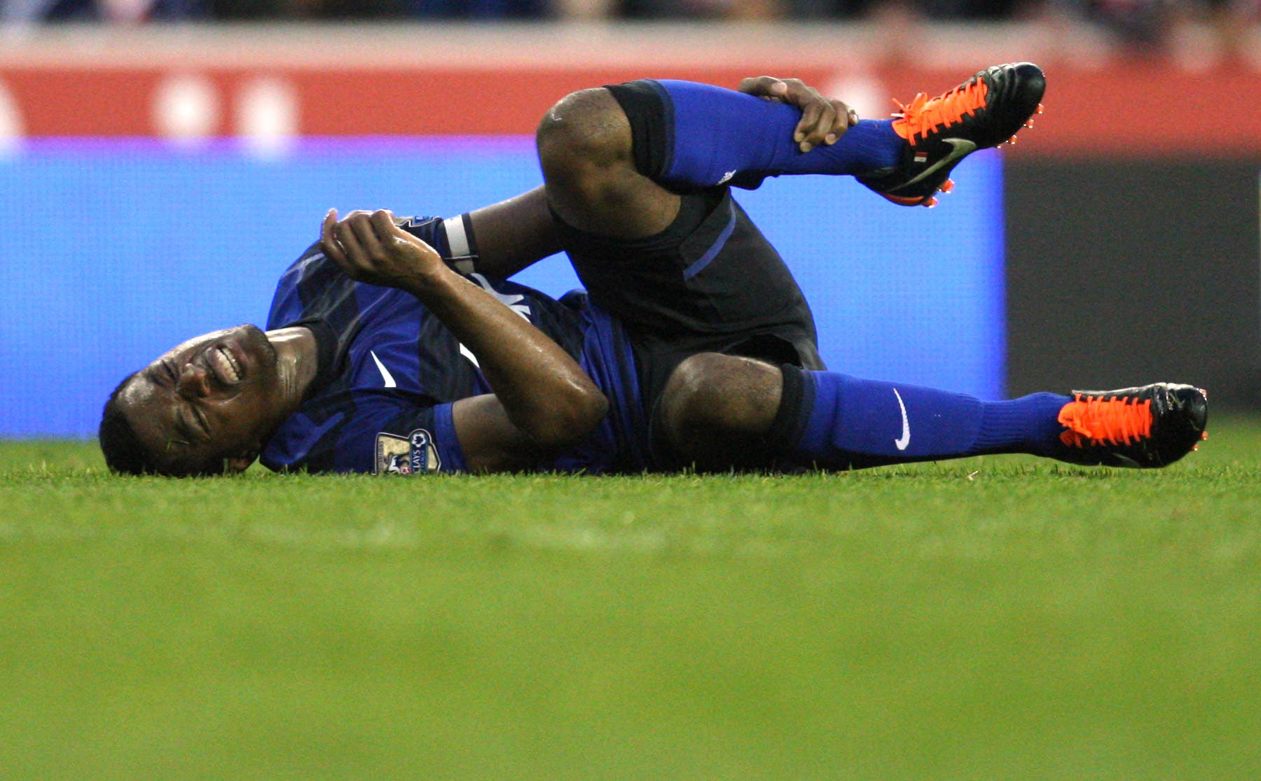 Football - Stoke City v Manchester United - Barclays Premier League - The Britannia Stadium - 11/12 - 24/9/11 Patrice Evra - Manchester United picks up an injury Mandatory Credit: Action Images / Carl Recine EDITORIAL USE ONLY. No use with unauthorized audio, video, data, fixture lists, club/league logos or live services. Online in-match use limited to 45 images, no video emulation. No use in betting, games or single club/league/player publications. Please contact your account manager for further details.
