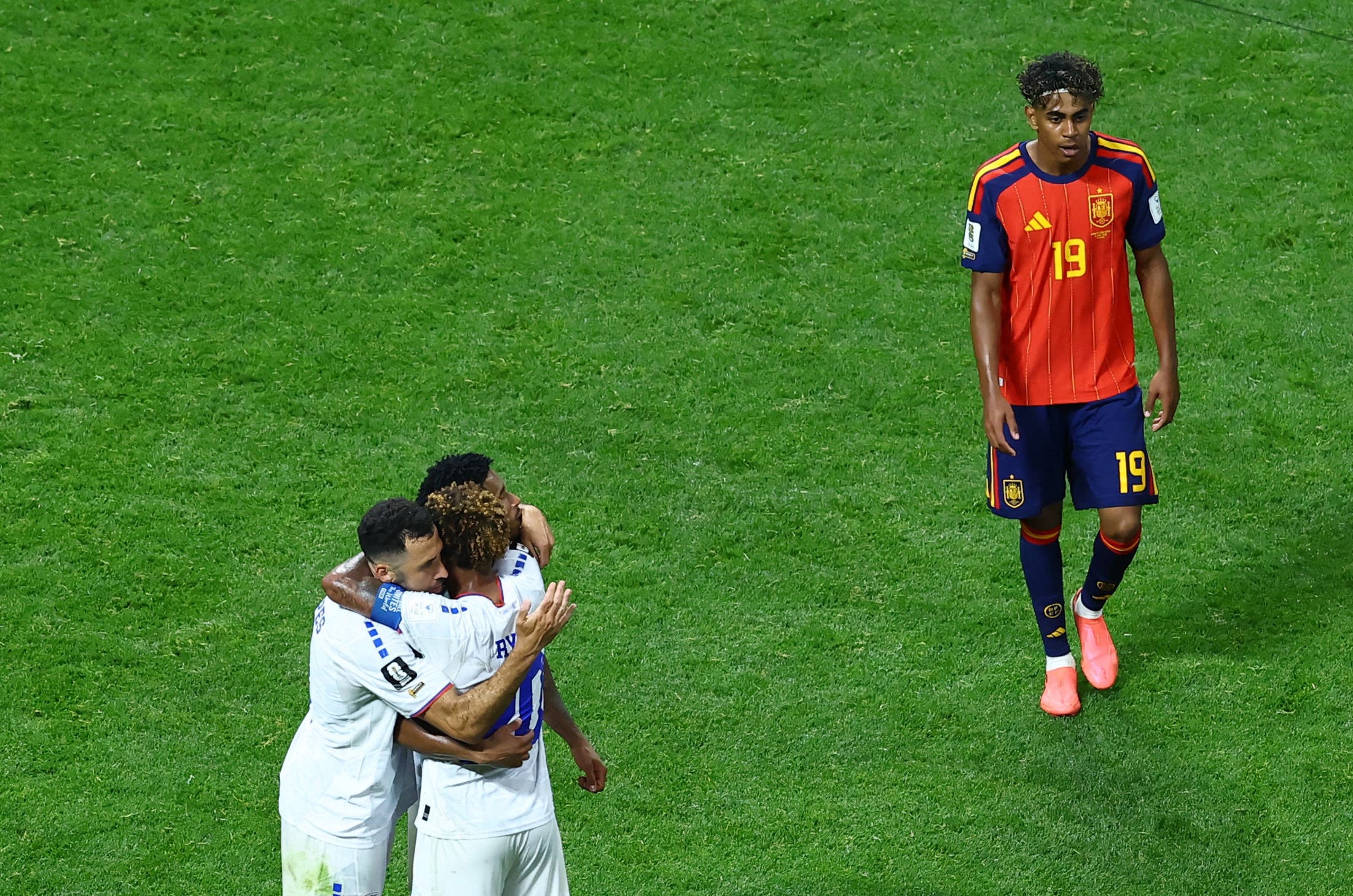 Soccer Football - FIFA World Cup 2026 - Group H - Spain v Cape Verde - Atlanta Stadium, Atlanta, Georgia, U.S. - June 15, 2026 Cape Verde's Pico Lopes, Ryan Mendes and Joao Paulo celebrate as Spain's Lamine Yamal looks dejected after the match REUTERS/Bernadett Szabo