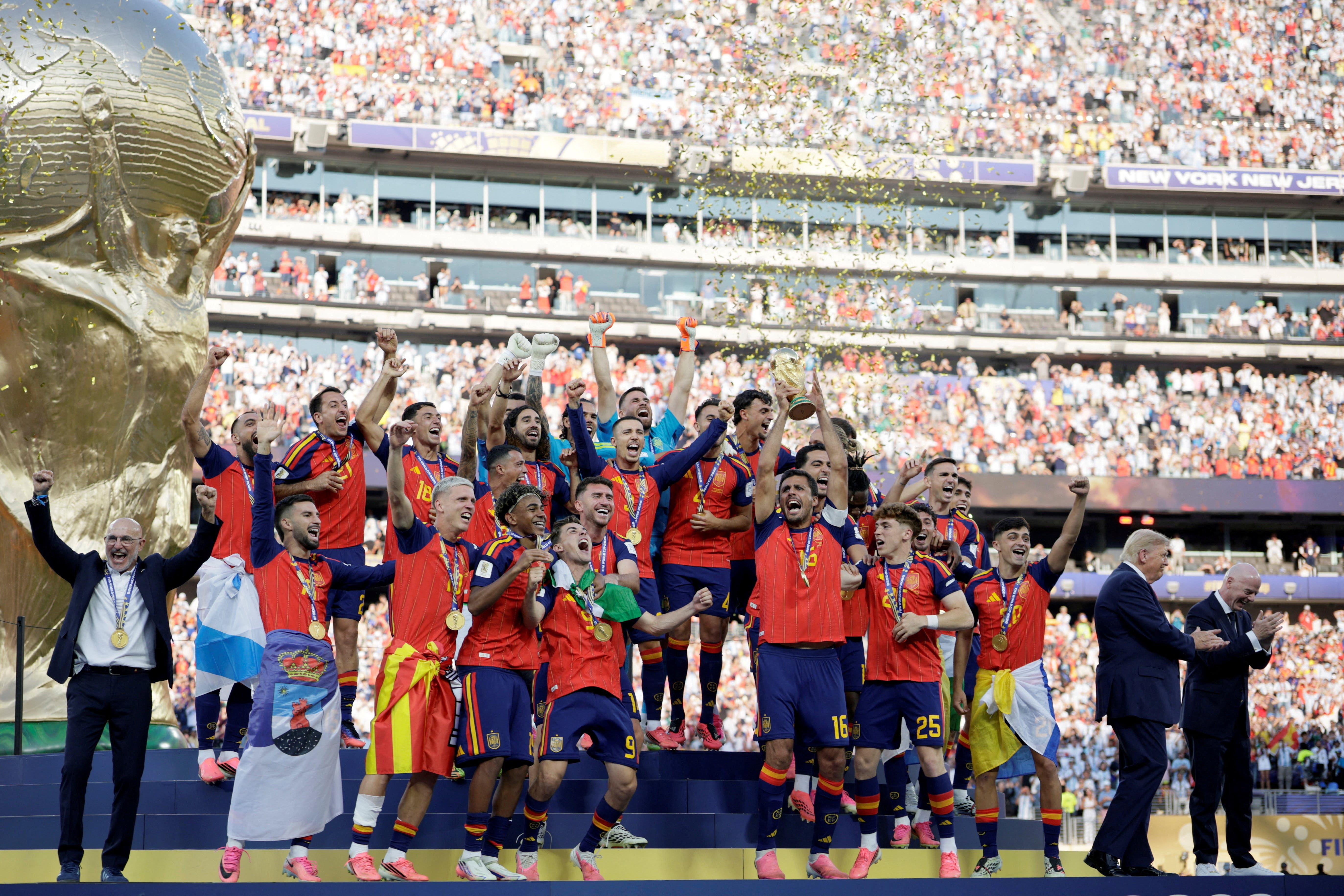 U.S. President Donald Trump and FIFA President Gianni Infantino applaud after presenting the FIFA World Cup trophy to Spain after its victory in the 2026 World Cup final at New York New Jersey Stadium in East Rutherford, New Jersey, U.S., July 19, 2026. REUTERS/Evan Vucci  TPX IMAGES OF THE DAY

