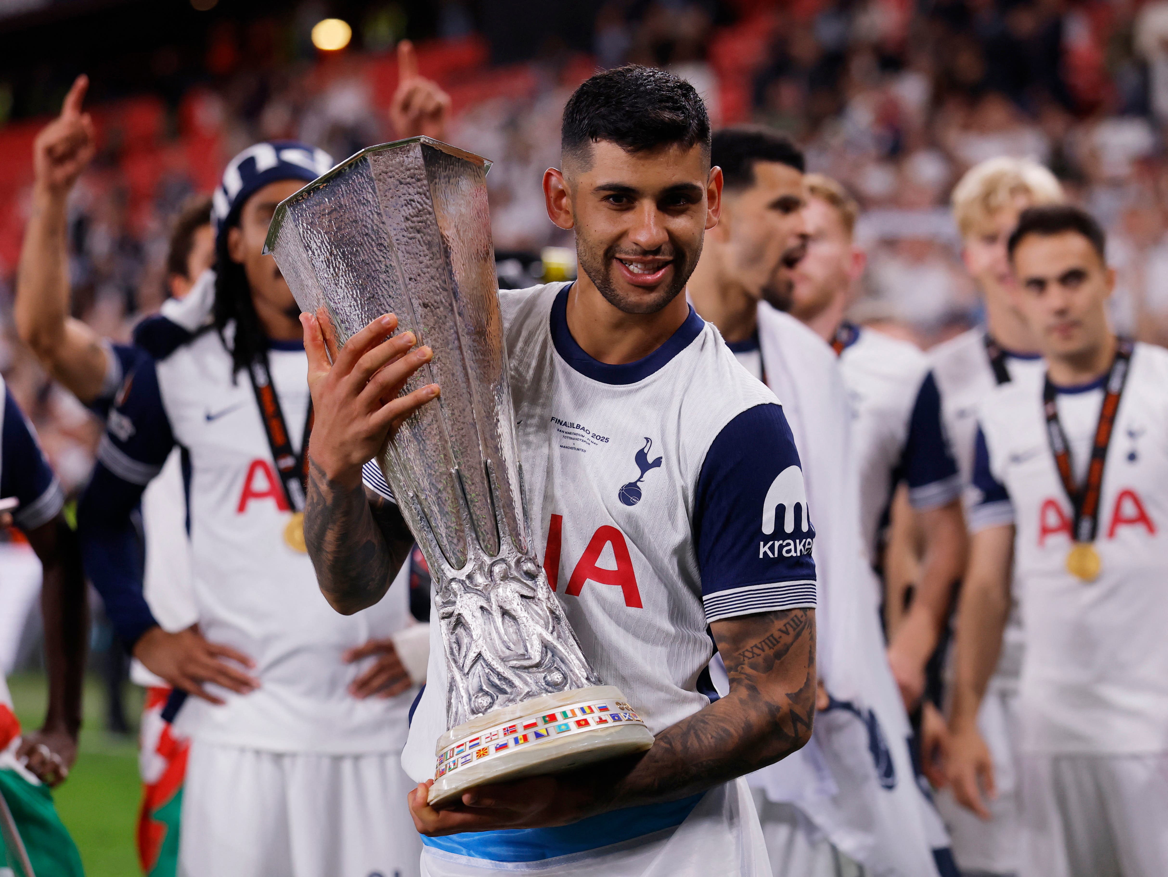 Soccer Football - Europa League - Final - Tottenham Hotspur v Manchester United - San Mames, Bilbao, Spain - May 21, 2025 Tottenham Hotspur's Cristian Romero celebrates with the trophy after winning the Europa League Final REUTERS/Andrew Couldridge