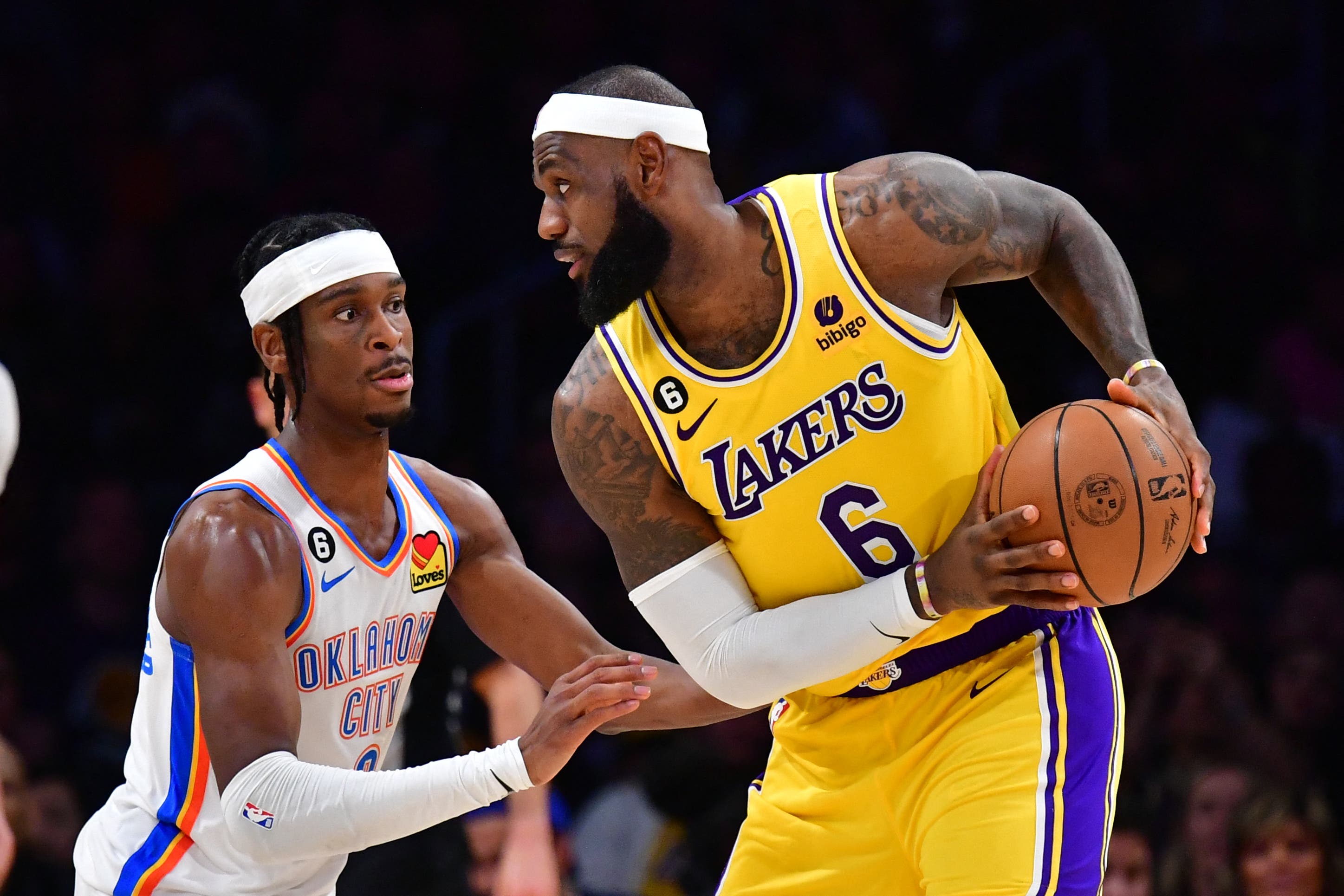 Shai Gilgeous-Alexander de los Oklahoma City Thunder y LeBron James de Los Angeles Lakers enfrentándose durante la temporada 2025 de la NBA.
