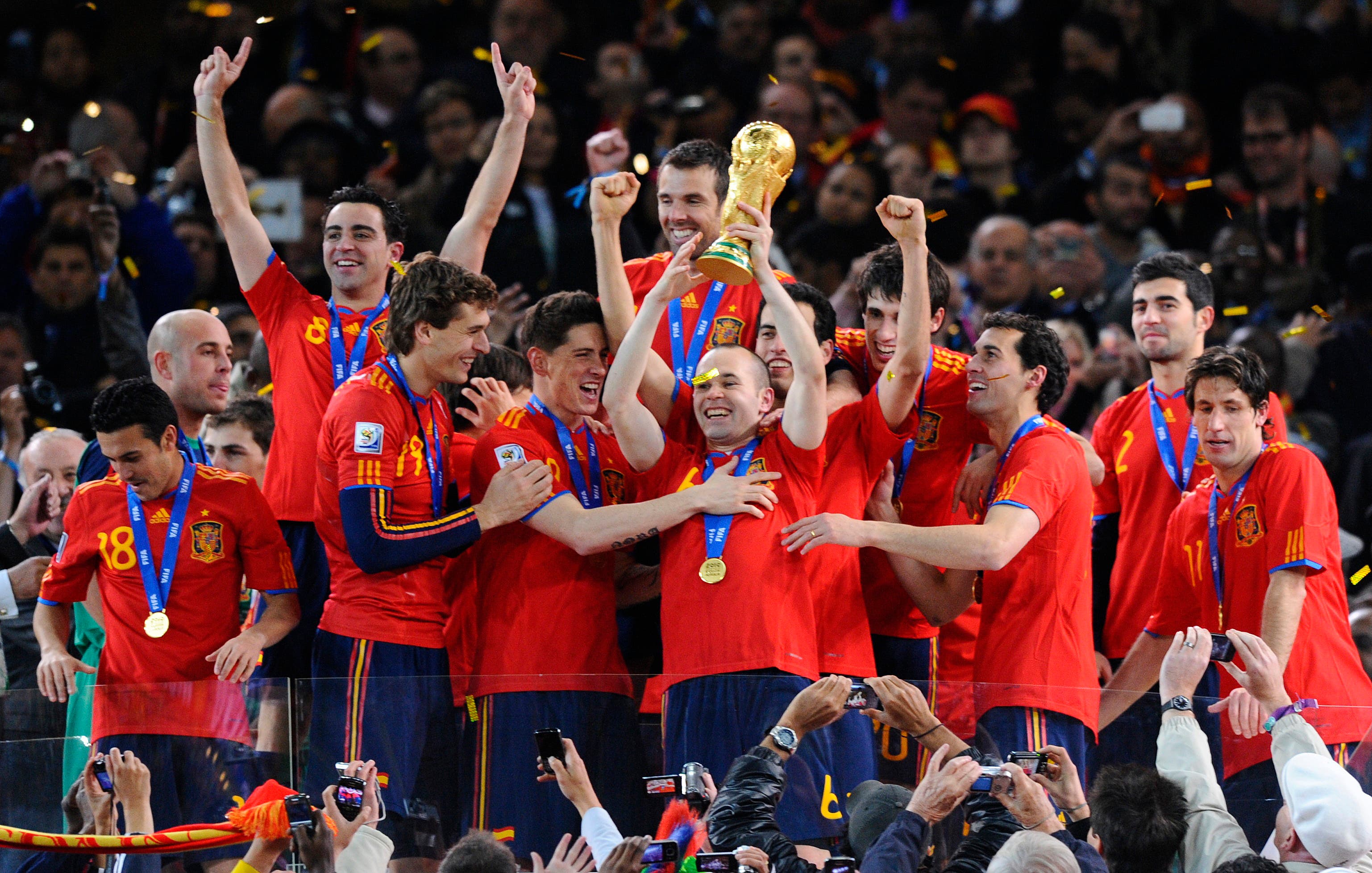 Football - Holland v Spain FIFA World Cup Final - South Africa 2010 - Soccer City Stadium, Johannesburg, South Africa - 11/7/10 Spain's Andres Iniesta lifts the FIFA World Cup trophy as he celebrates with his team mates Mandatory Credit: Action Images / Jason Cairnduff Livepic