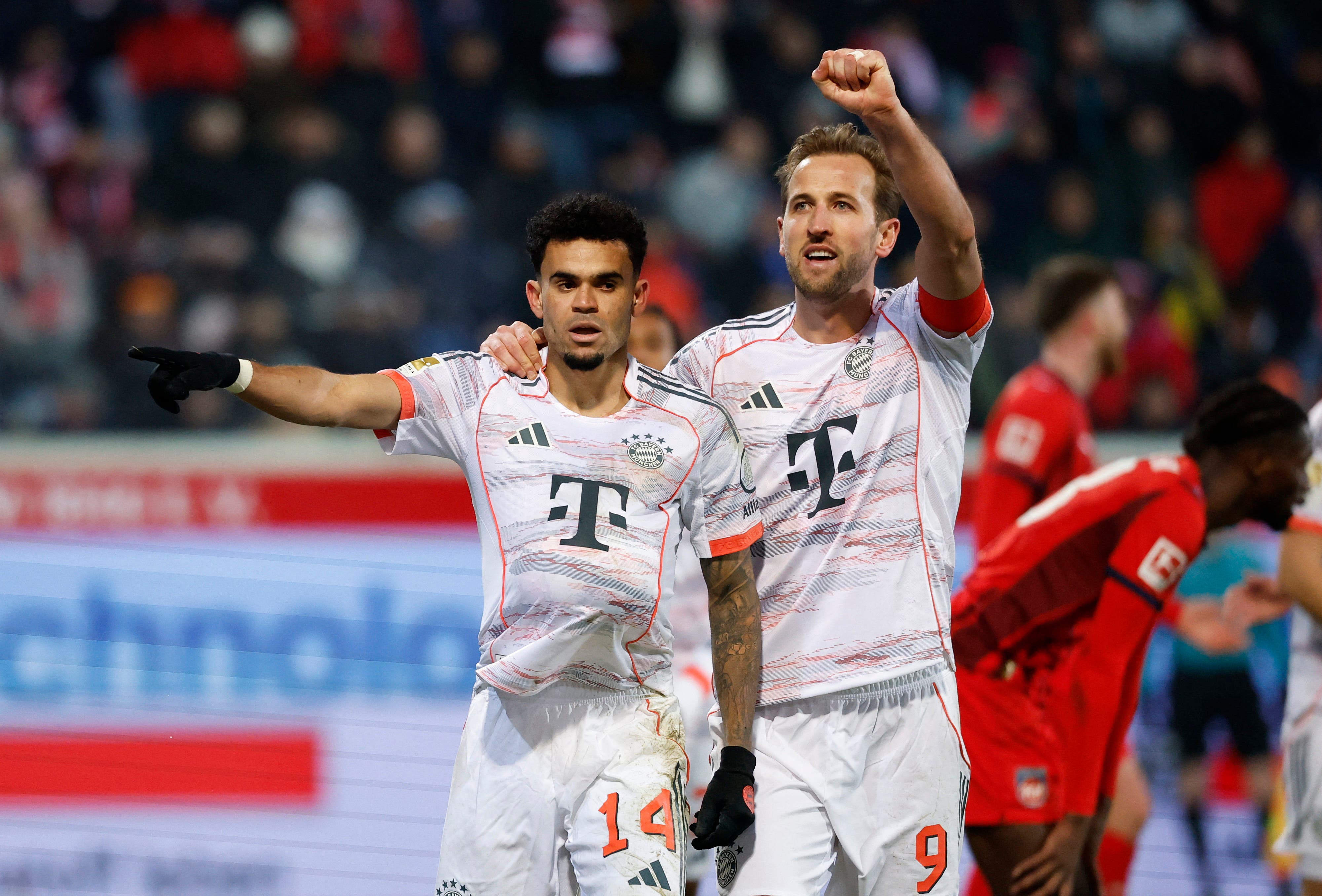 Soccer Football - Bundesliga - 1. FC Heidenheim v Bayern Munich - Voith-Arena, Heidenheim, Germany - December 21, 2025 Bayern Munich's Luis Diaz celebrates scoring their third goal with Harry Kane REUTERS/Heiko Becker DFL REGULATIONS PROHIBIT ANY USE OF PHOTOGRAPHS AS IMAGE SEQUENCES AND/OR QUASI-VIDEO.
