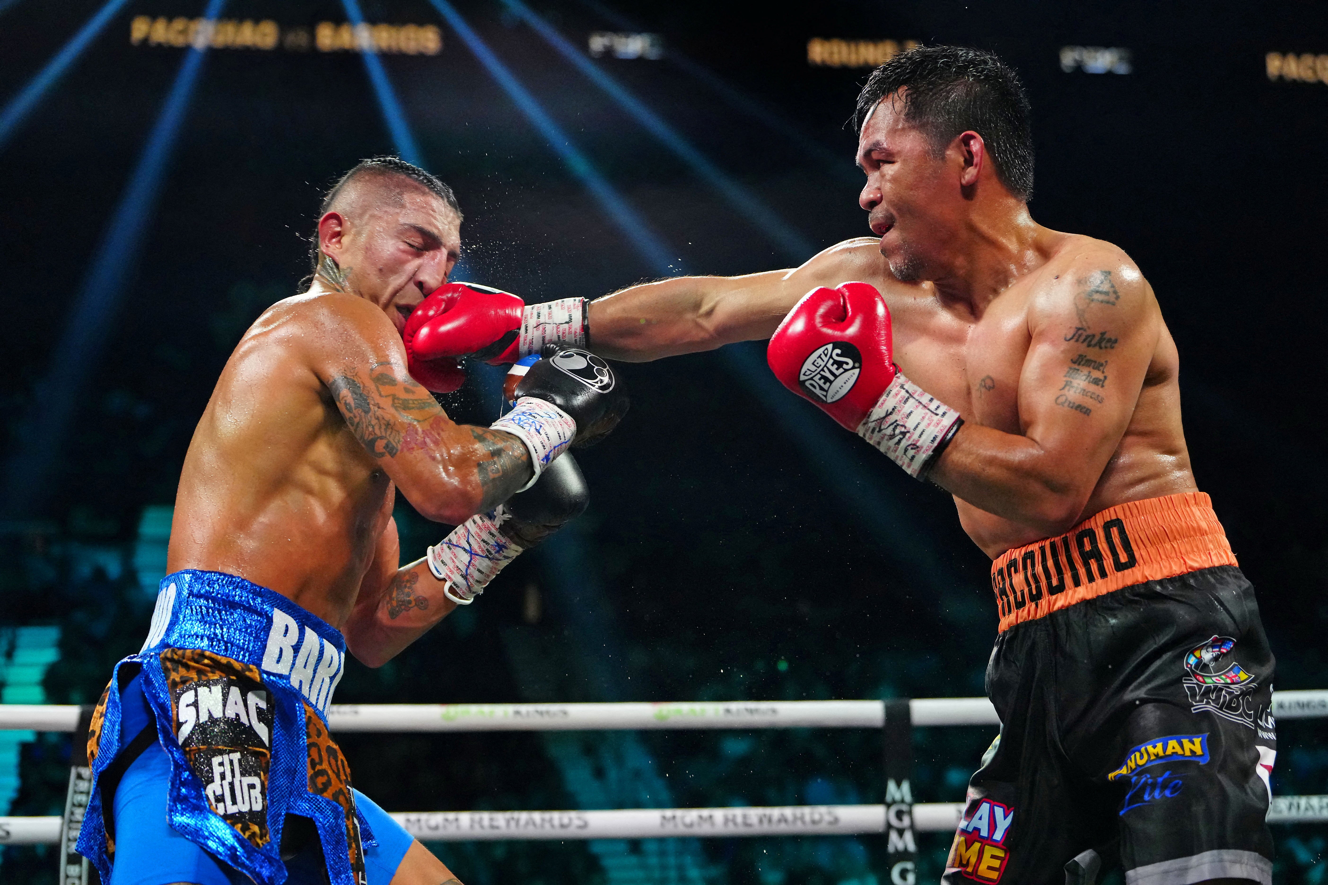 Manny Pacquiao punches Mario Barrios in their July 2025 welterweight title fight