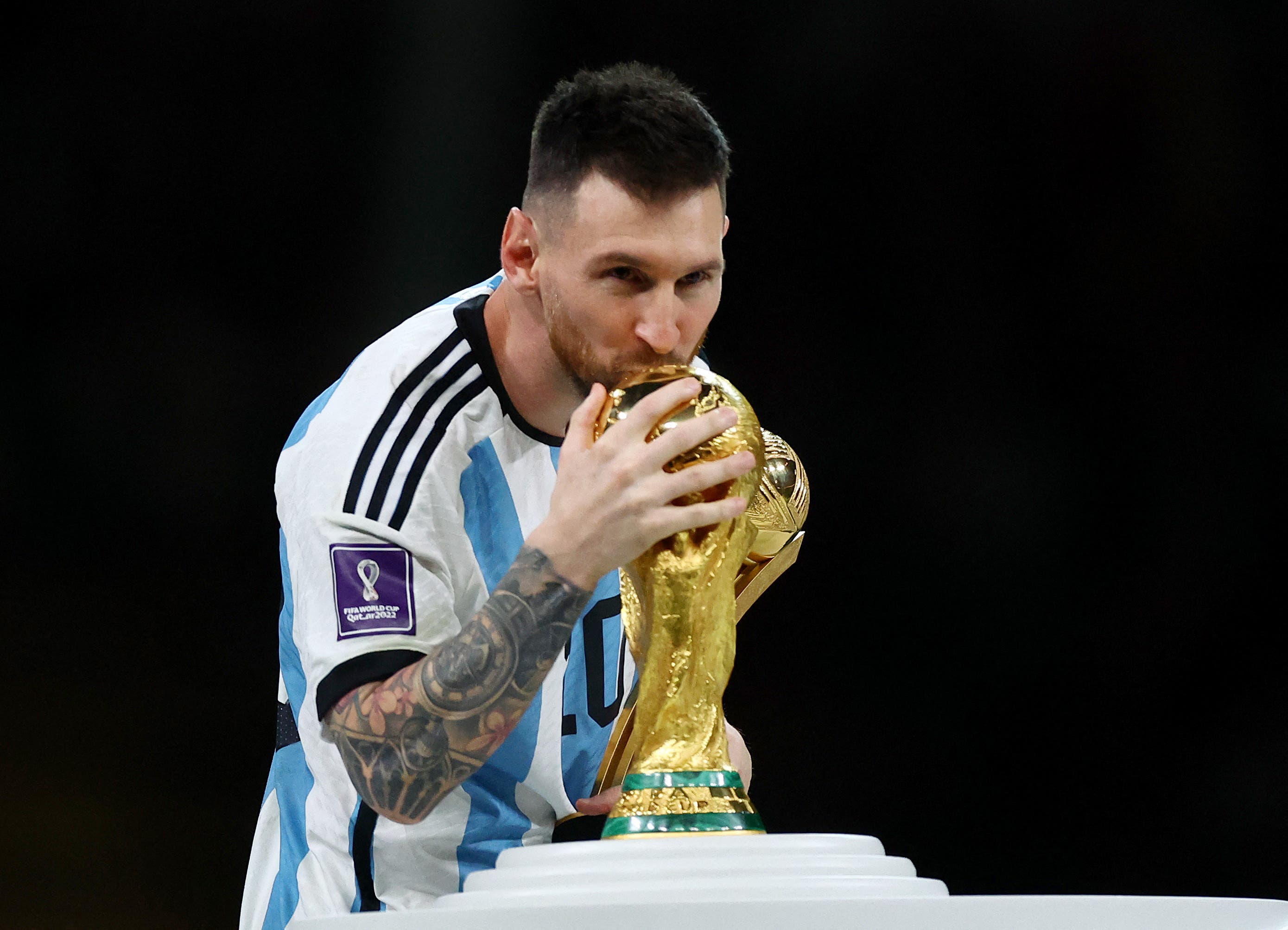 Soccer Football - FIFA World Cup Qatar 2022 - Final - Argentina v France - Lusail Stadium, Lusail, Qatar - December 18, 2022 Argentina's Lionel Messi kisses the trophy as he celebrates winning the World Cup during the trophy ceremony REUTERS/Hannah Mckay