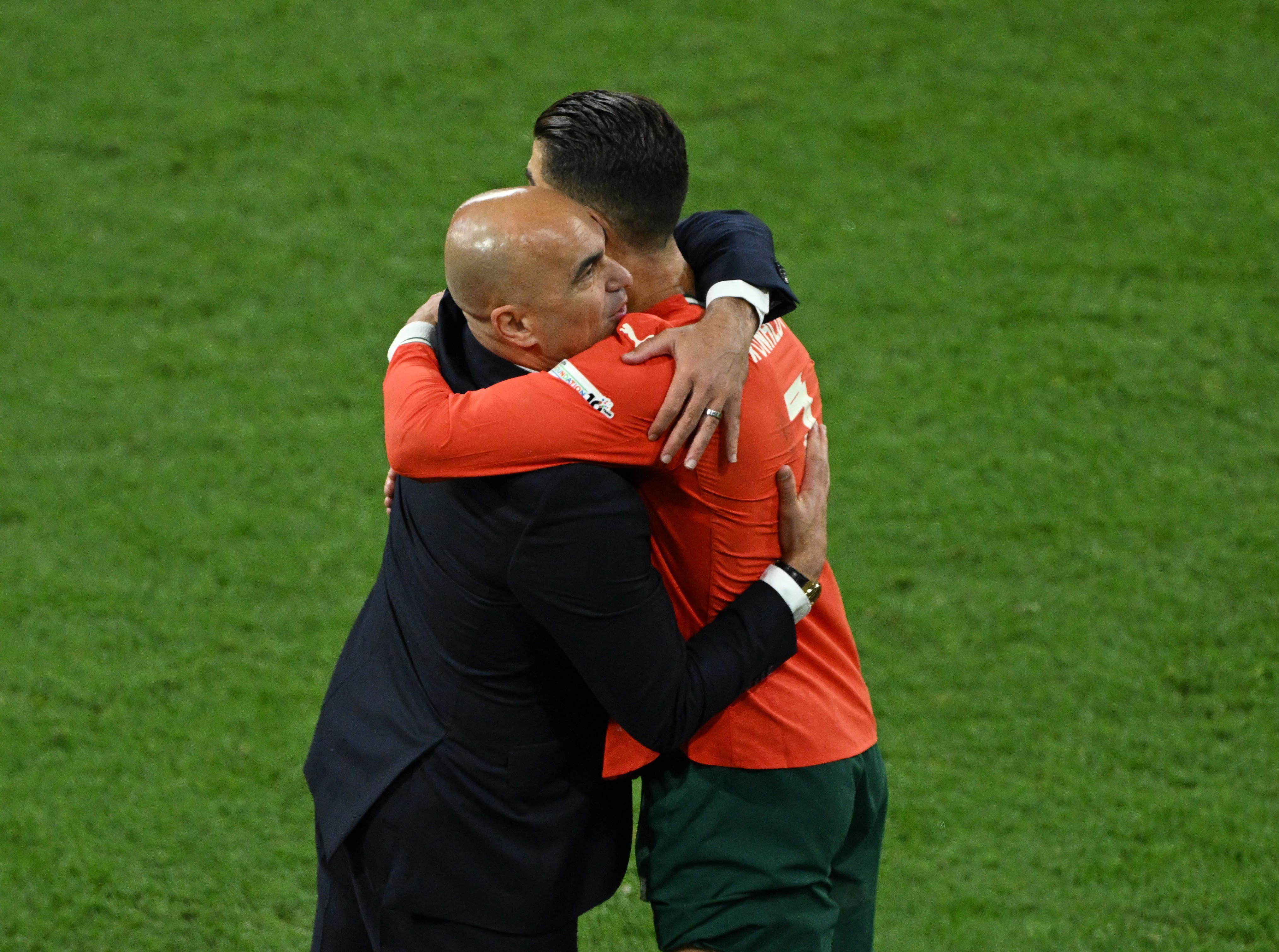 Soccer Football - Nations League - Final - Portugal v Spain - Allianz Arena, Munich, Germany - June 8, 2025 Portugal's Cristiano Ronaldo with coach Roberto Martinez after being substituted REUTERS/Annegret Hilse

