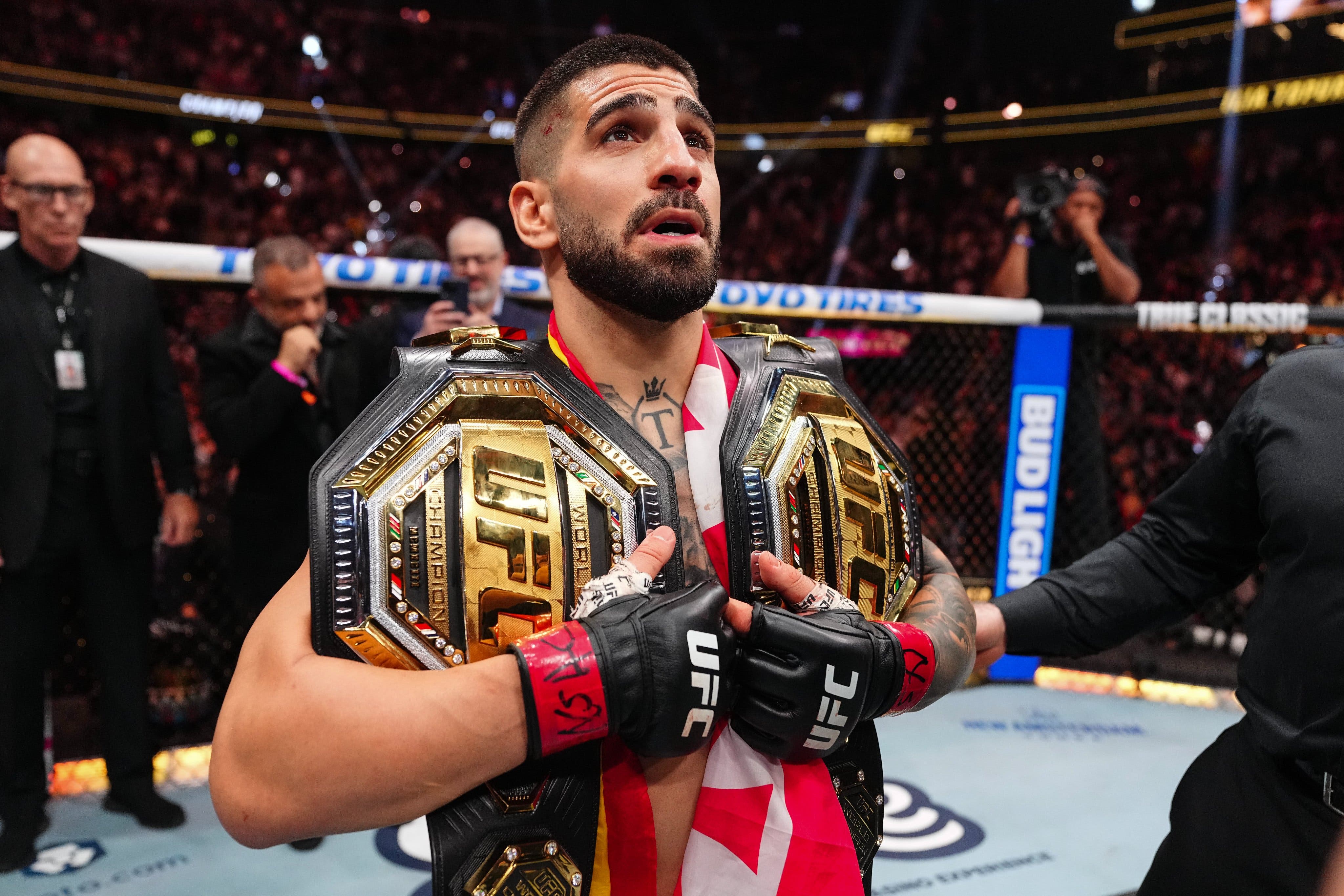 Ilia Topuria hold his two belts as UFC Champion