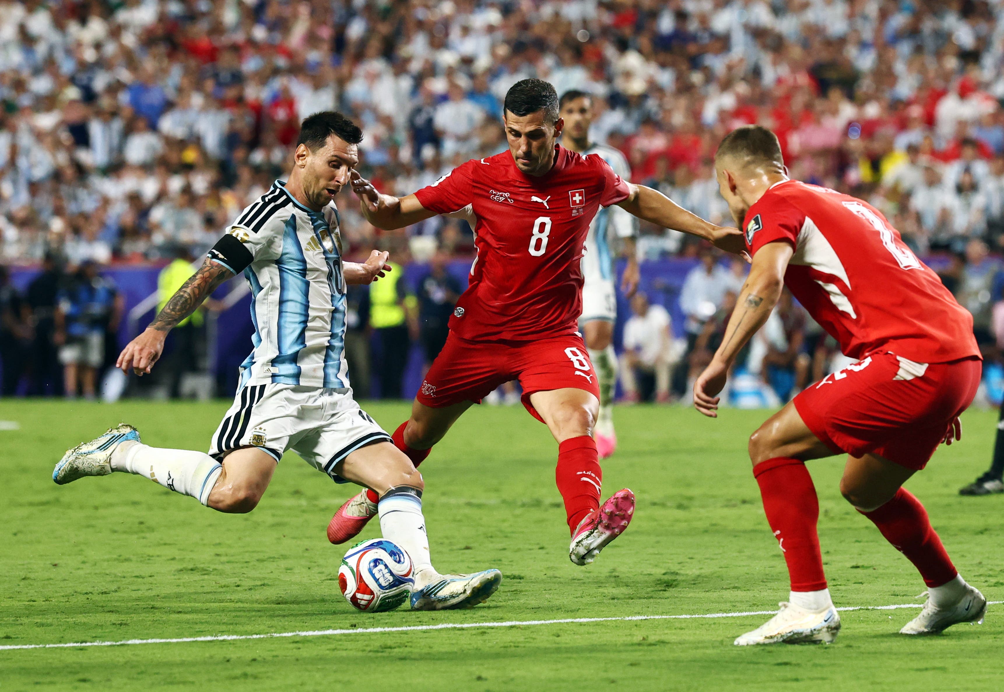 Soccer Football - FIFA World Cup 2026 - Quarter Final - Argentina v Switzerland - Kansas City Stadium, Kansas City, Missouri, U.S. - July 11, 2026 Argentina's Lionel Messi in action with Switzerland's Remo Freuler and Miro Muheim REUTERS/Amanda Perobelli

