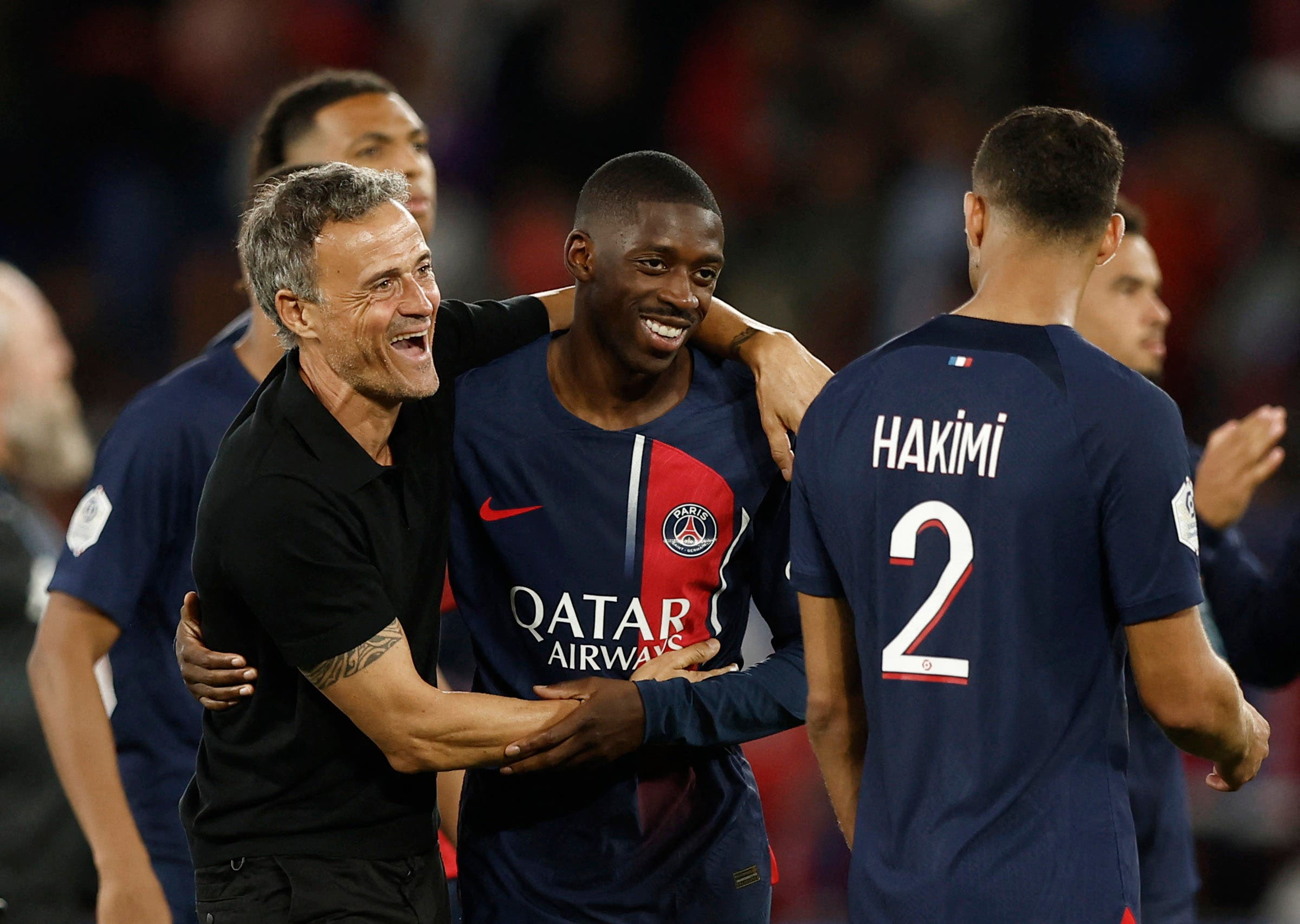 Soccer Football - France - Ligue 1 - Paris St Germain v RC Lens - Parc des Princes, Paris, France - August 26, 2023 Paris St Germain coach Luis Enrique celebrates after the match with Paris St Germain's Ousmane Dembele REUTERS/Benoit Tessier