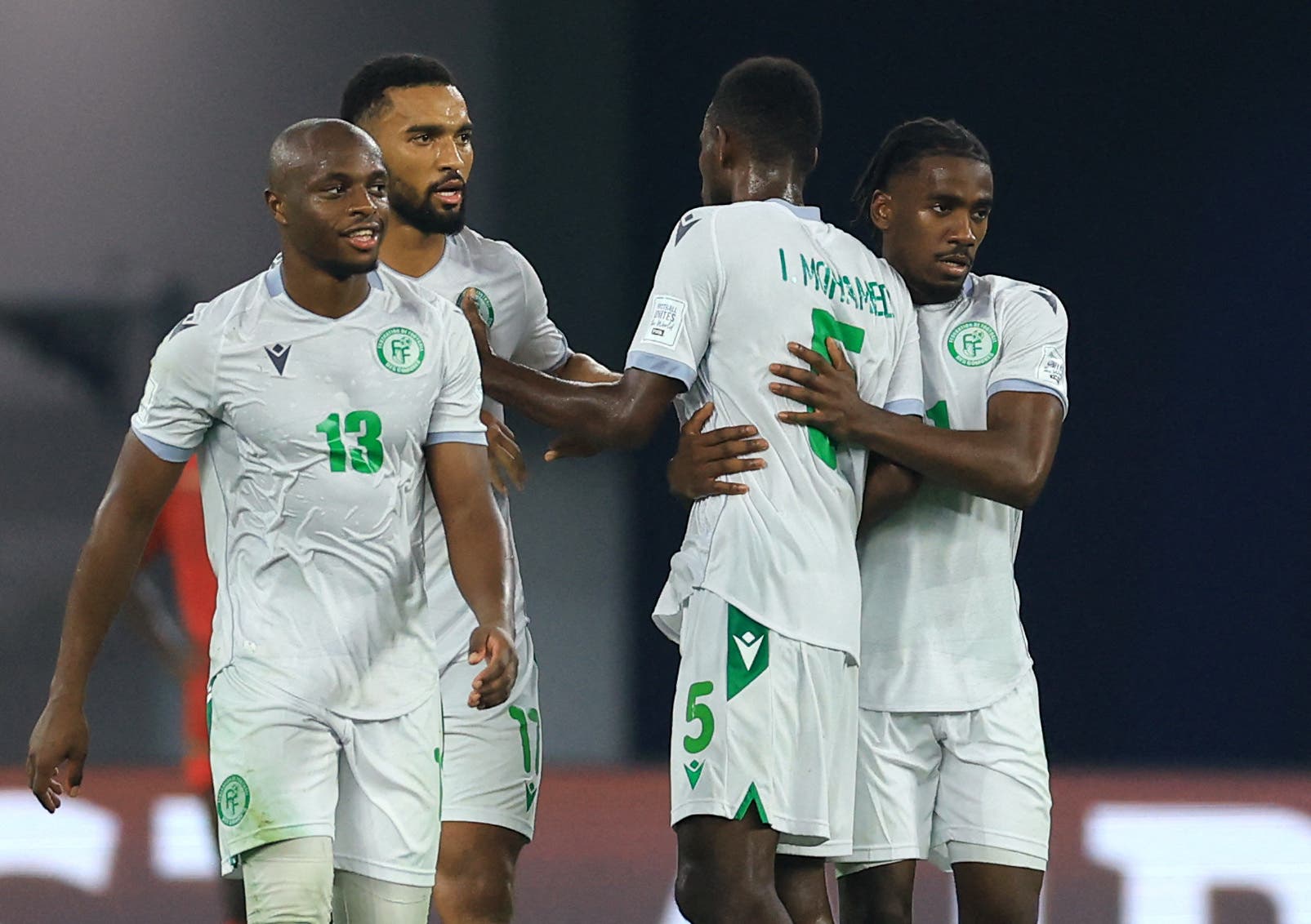 Soccer Football - FIFA Arab Cup - Qatar 2025 - Group B - Oman v Comoros - Stadium 974, Doha, Qatar - December 8, 2025 Comoros' Nassuir Hamidou celebrates scoring their first goal with teammates REUTERS/Thaier Al-Sudani