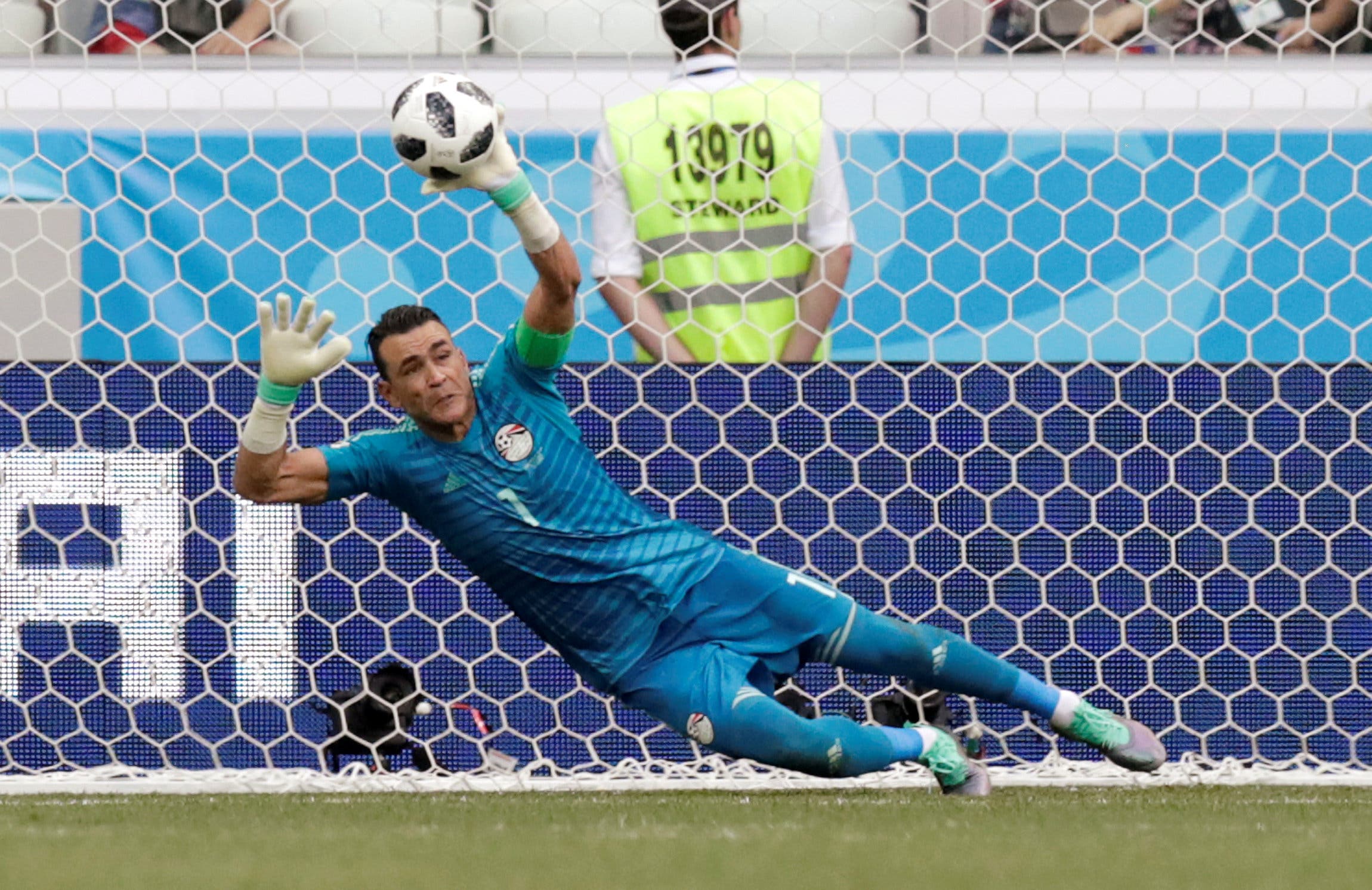 Soccer Football - World Cup - Group A - Saudi Arabia vs Egypt - Volgograd Arena, Volgograd, Russia - June 25, 2018 Egypt's Essam El-Hadary saves a penalty from Saudi Arabia's Fahad Al-Muwallad (not pictured) REUTERS/Ueslei Marcelino