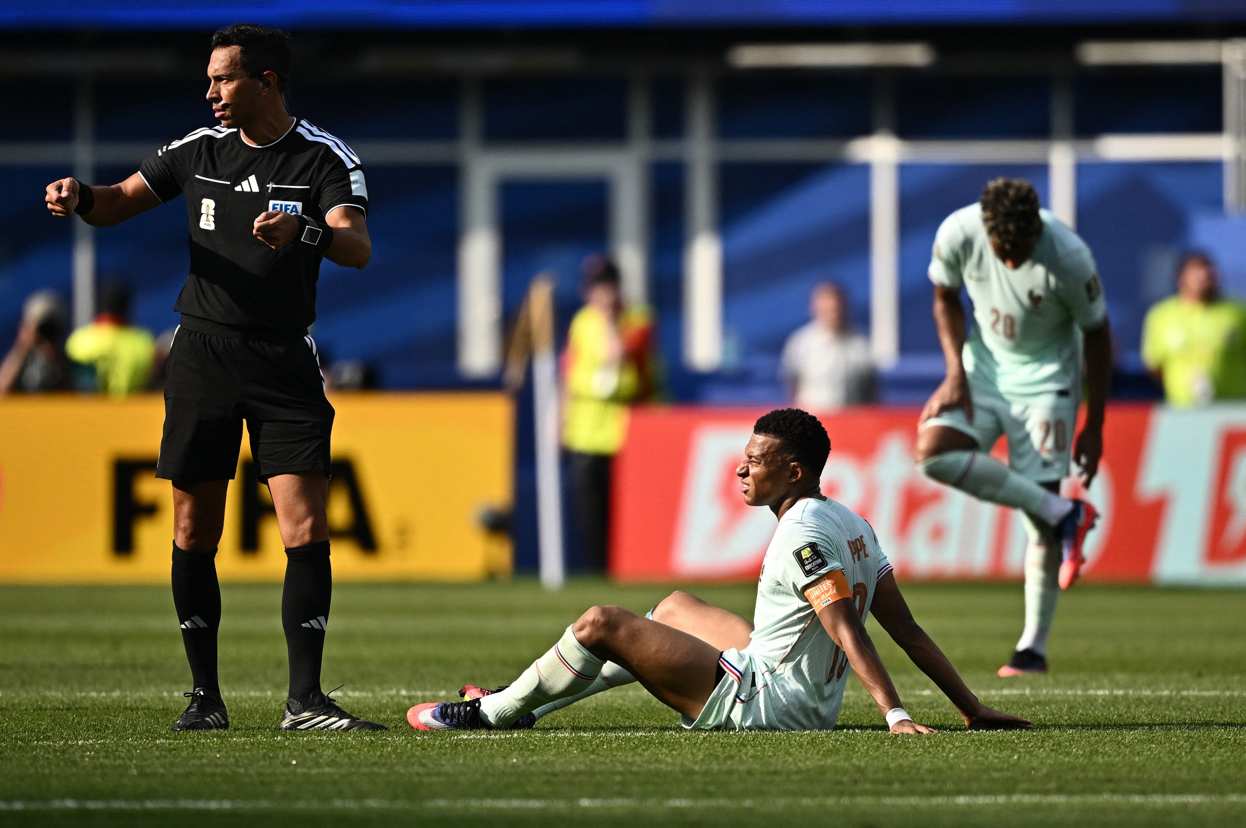 Soccer Football - FIFA World Cup 2026 - Quarter Final - France v Morocco - Boston Stadium, Foxborough, Massachusetts, U.S. - July 9, 2026 France's Kylian Mbappe reacts after sustaining an injury as referee Facundo Tello looks on REUTERS/Dylan Martinez