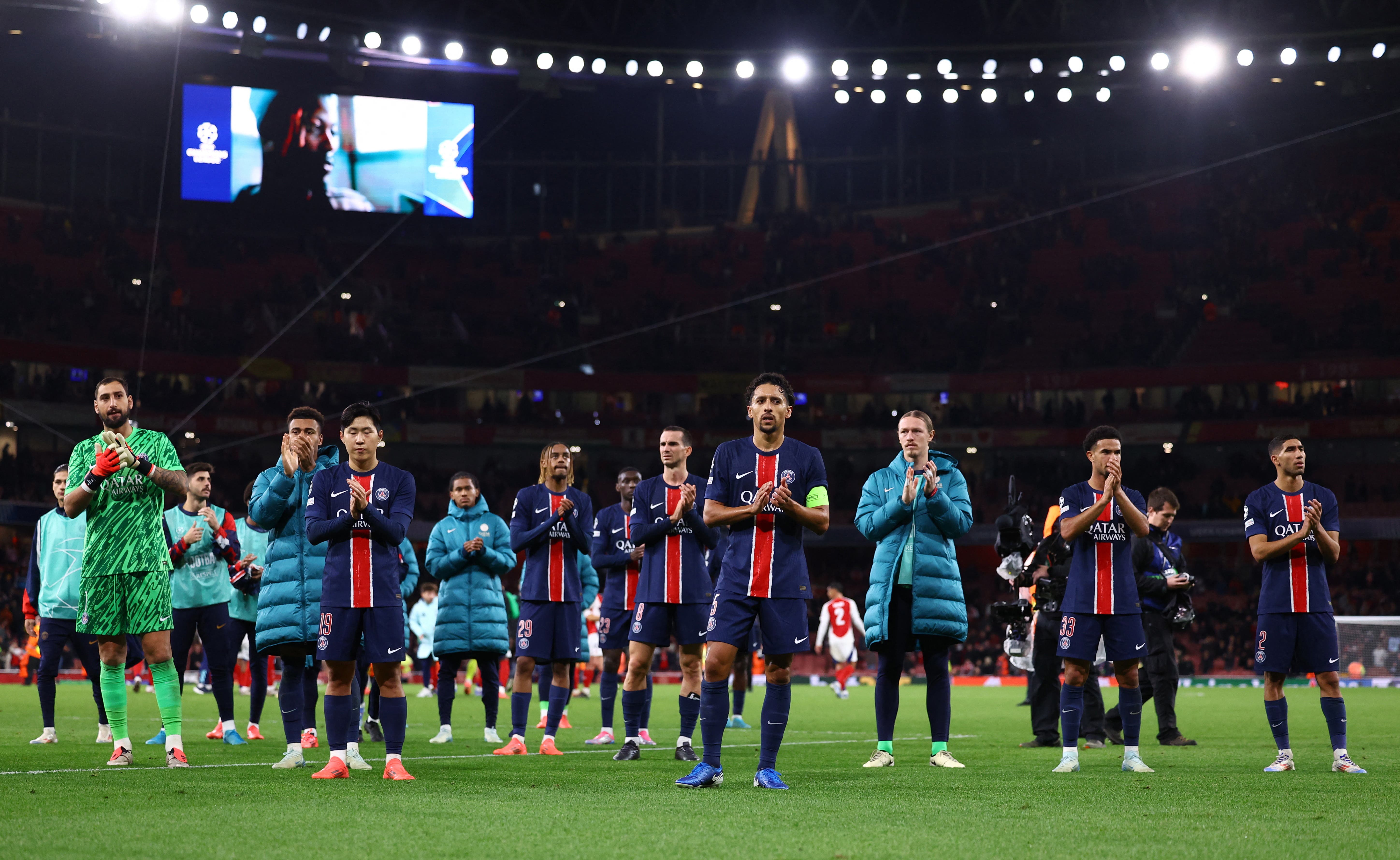 Paris St Germain's Marquinhos with teammates look dejected after the match 
