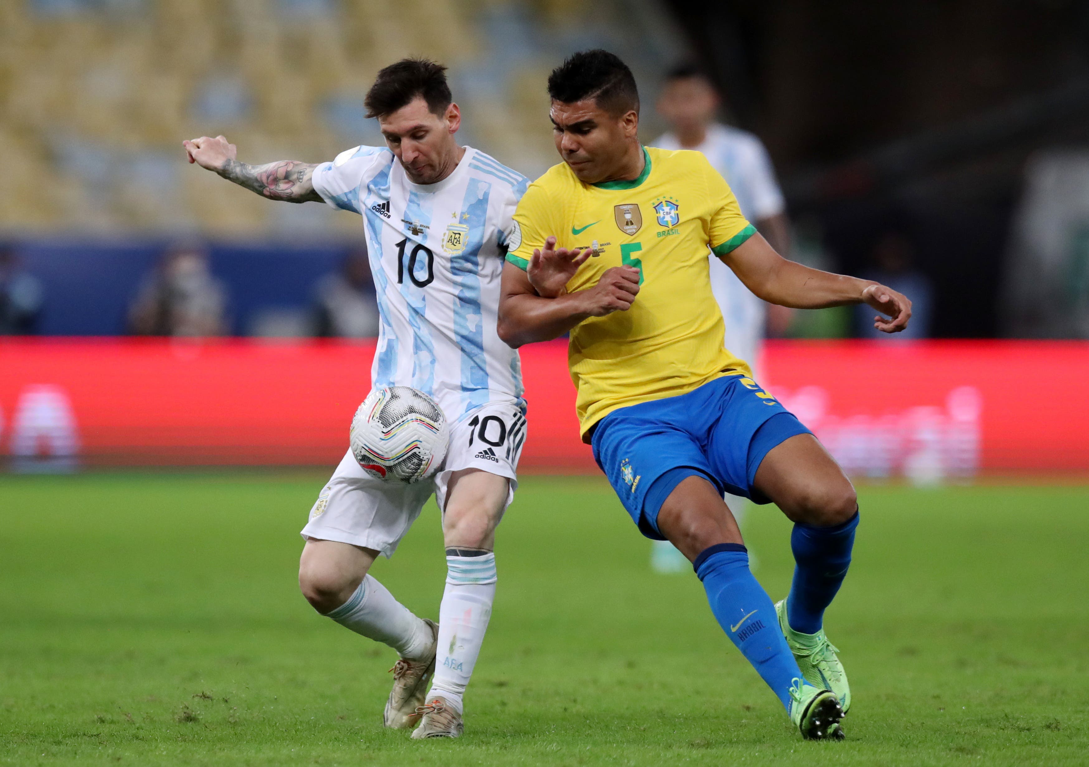 Soccer Football - Copa America 2021 - Final - Brazil v Argentina - Estadio Maracana, Rio de Janeiro, Brazil - July 10, 2021 Argentina's Lionel Messi in action with Brazil's Casemiro REUTERS/Amanda Perobelli